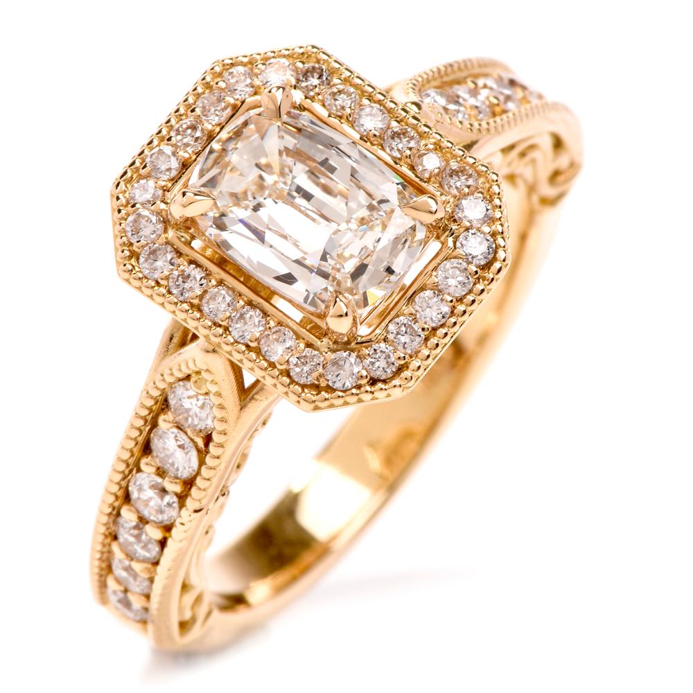 This beautiful diamond engagement ring is crafted in 18K yellow gold. Displaying a prominent four prong set cushion brilliant GIA certified diamond approx. 0.93 CT, J color, VS1 clarity. Surrounded by a halo of pave set small round-cut diamonds,