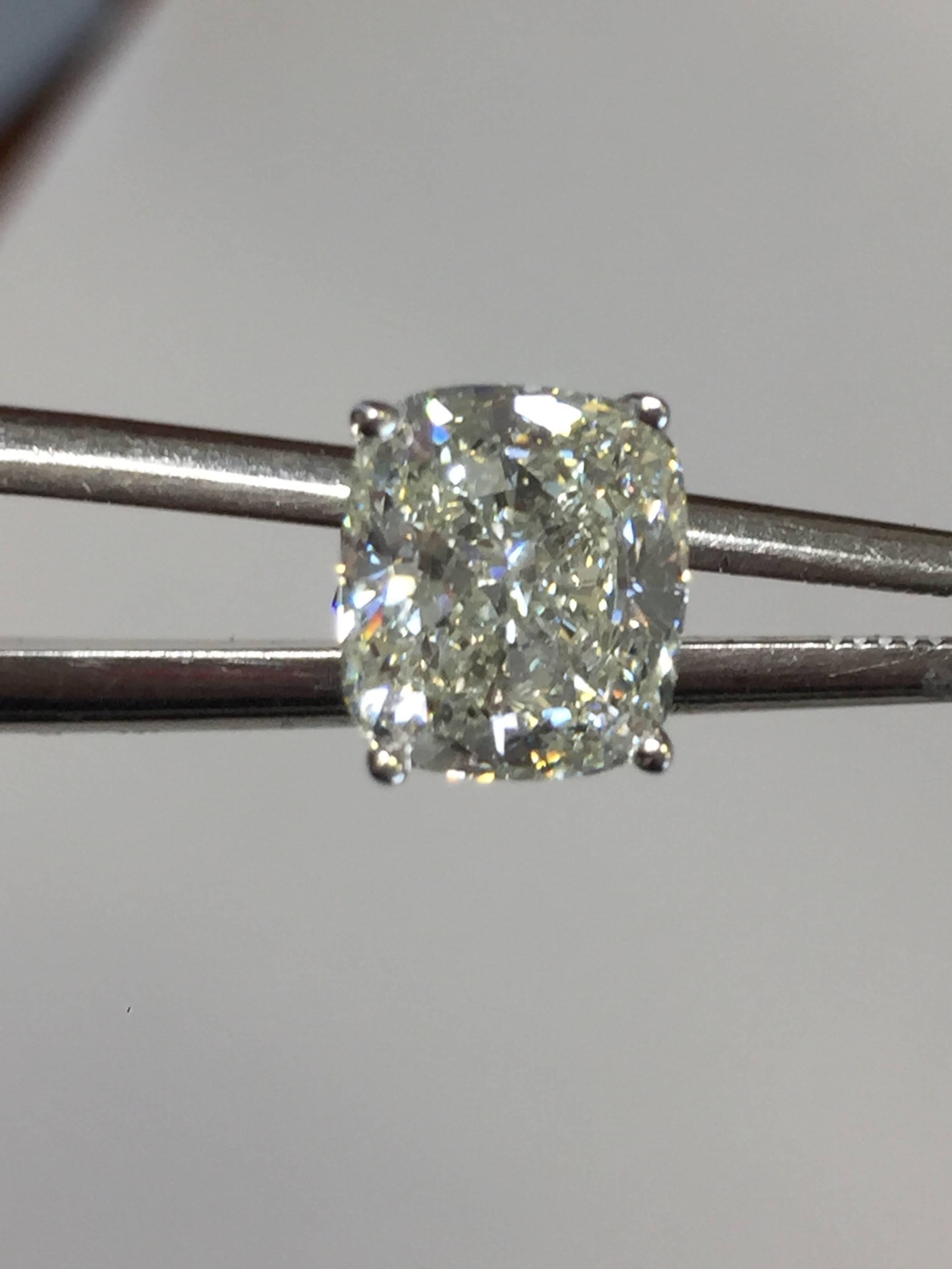 6.02 carats of bright white cushion K VS1-VS2 diamonds in 18k white gold mountings.  GIA lab report available.