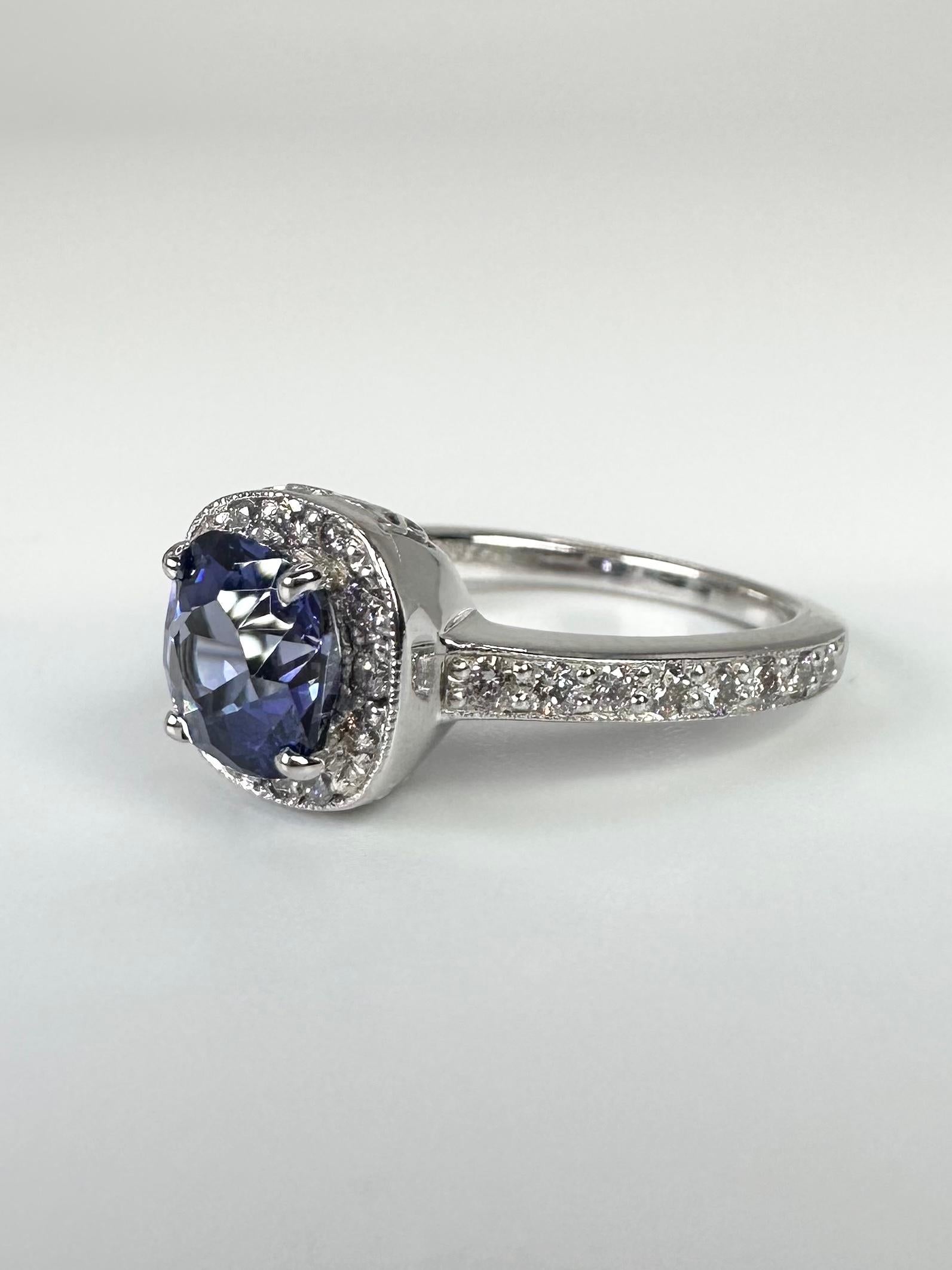 Important Tanzanite ring flanked by a diamond on either side, made with a gentle halo in platinum. Stunning rare color!

GOLD: 14KT white gold
NATURAL TANZANITE(S)
Clarity/Color: Slightly Included/Light Violet
Carat:0.80ct
NATURAL