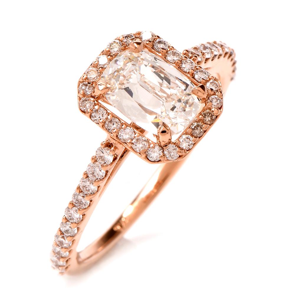 This stunning diamond engagement ring is crafted in 18-karat rose gold. Displaying a prominent four-prong set cushion brilliant GIA certified diamond approx. 0.94ct, J color, VVS2 clarity. Surrounded by a halo and pave set shank of small round-cut