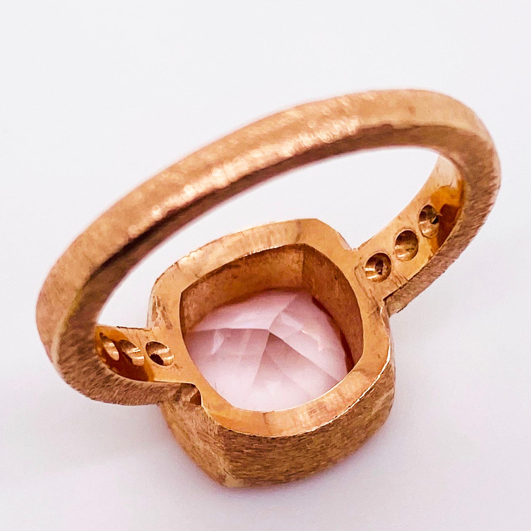 The custom morganite ring is a stunning piece with a genuine morganite gemstone set in a modern bezel setting. The morganite is cushion cut with a beautiful polish that sparkles brilliantly. The morganite is set in a hand fabricated satin bezel