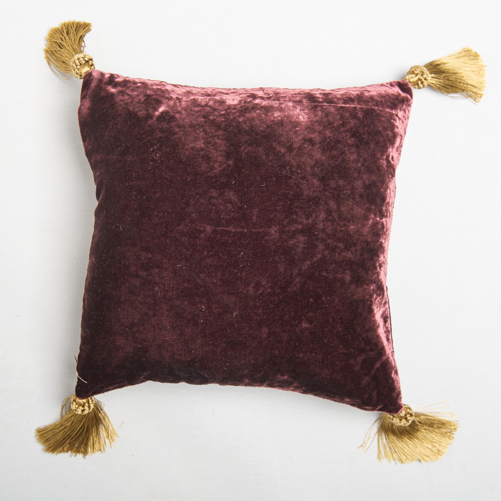 B/1624 -  Cushion or pillow in plum-colored velvet with bronze checkered design .
By Hope and Phillips -