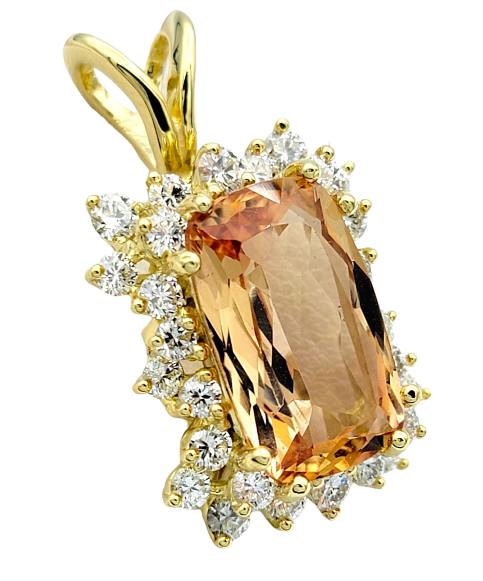 This beautiful large cushion peach topaz pendant exudes warmth and radiance, set in luxurious 18 karat yellow gold. The centerpiece, a captivating peach topaz gemstone, is expertly cut into a cushion shape, showcasing its vibrant hue and natural