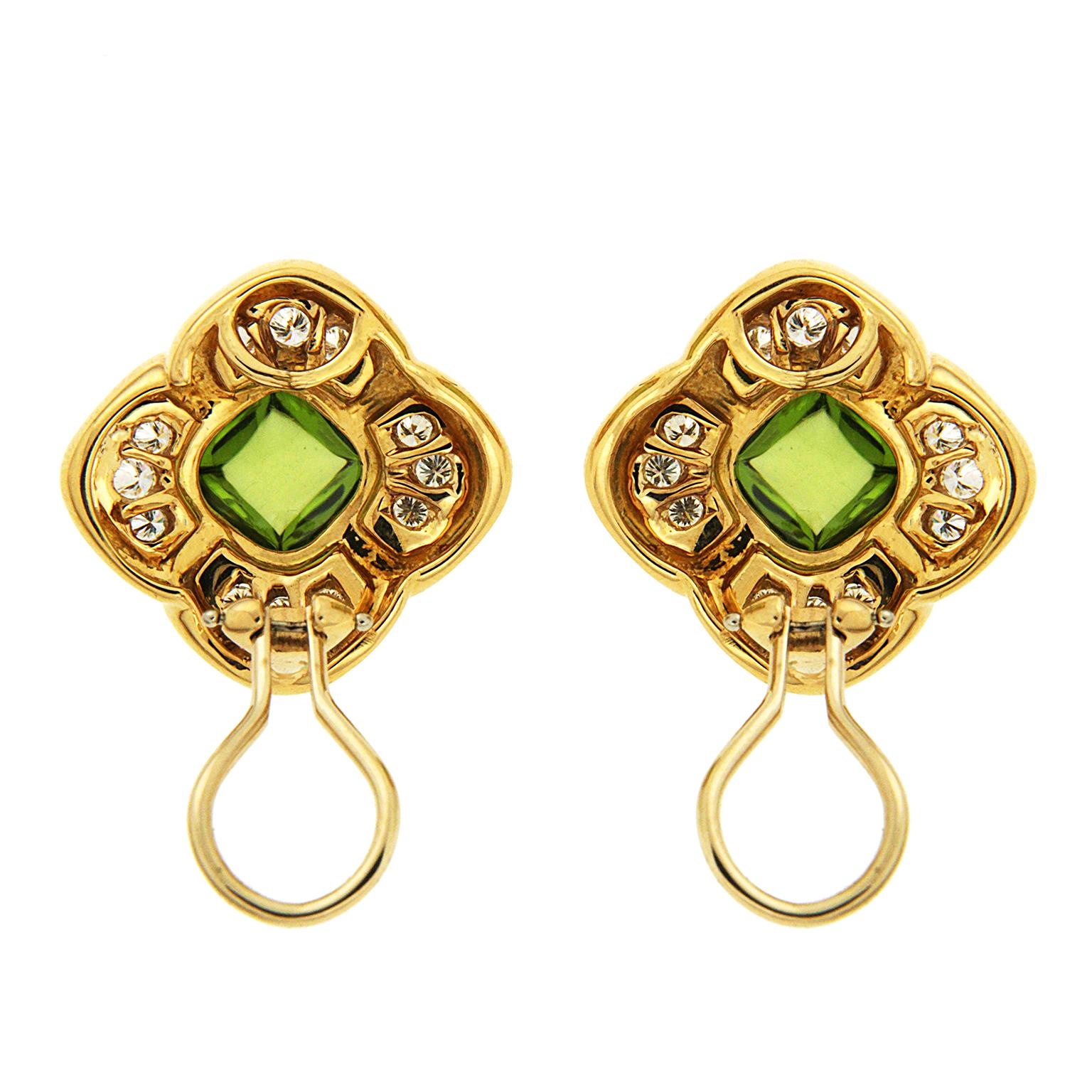 These earrings are made in 18kt yellow gold with cushion cabochon / sugar loaf peridots in the center and 1.20 carat total weight of round brilliant diamonds finished with clip backs.