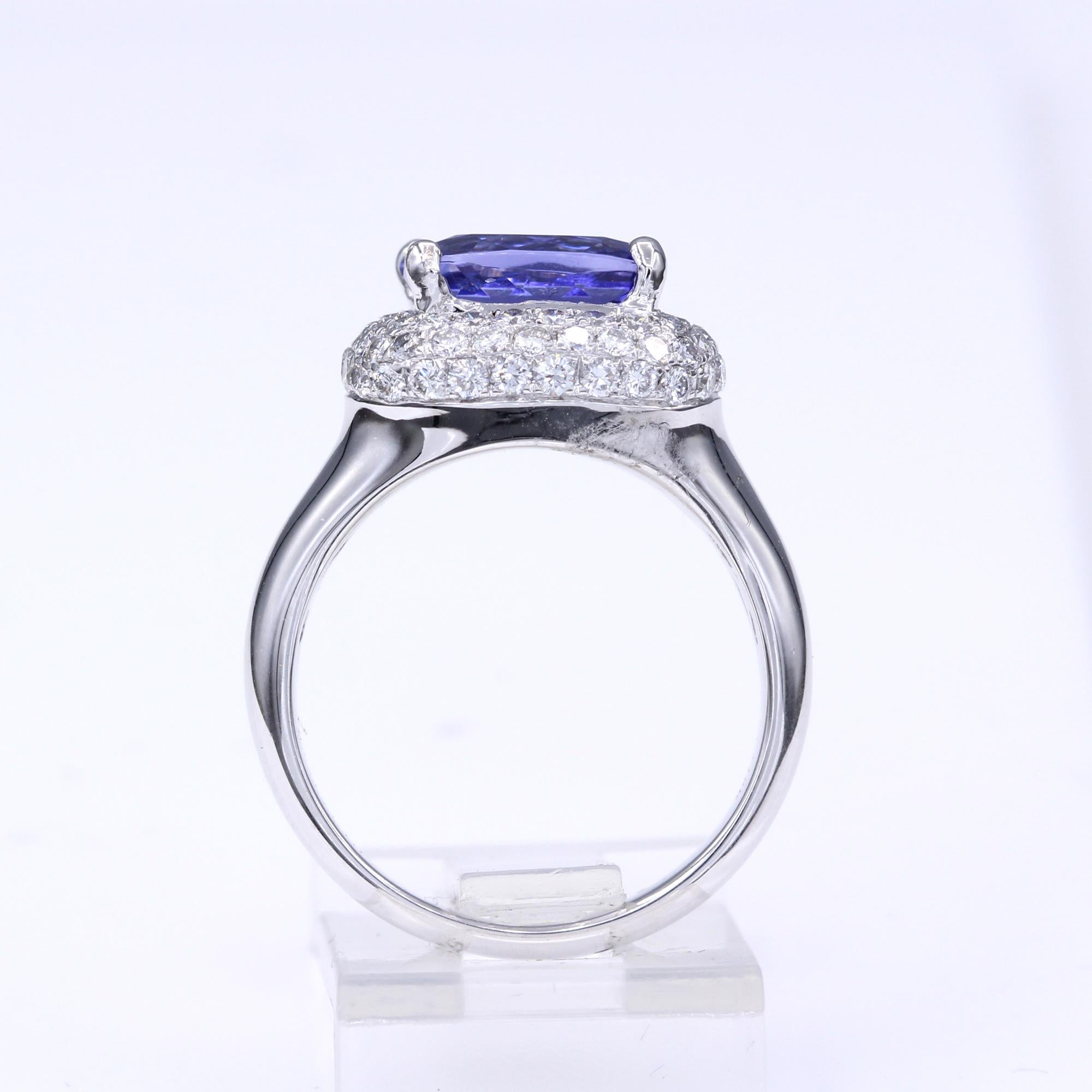 Fancy Tanzanite Ring & Diamonds, Modified Cushion shape Tanzanite AAA brilliant deep purple 3.64 carat 9 x 7 mm.
Total all Diamonds 1.12 carat GH-SI, 18k White Gold 3.65 Grams, Finger Size 7.