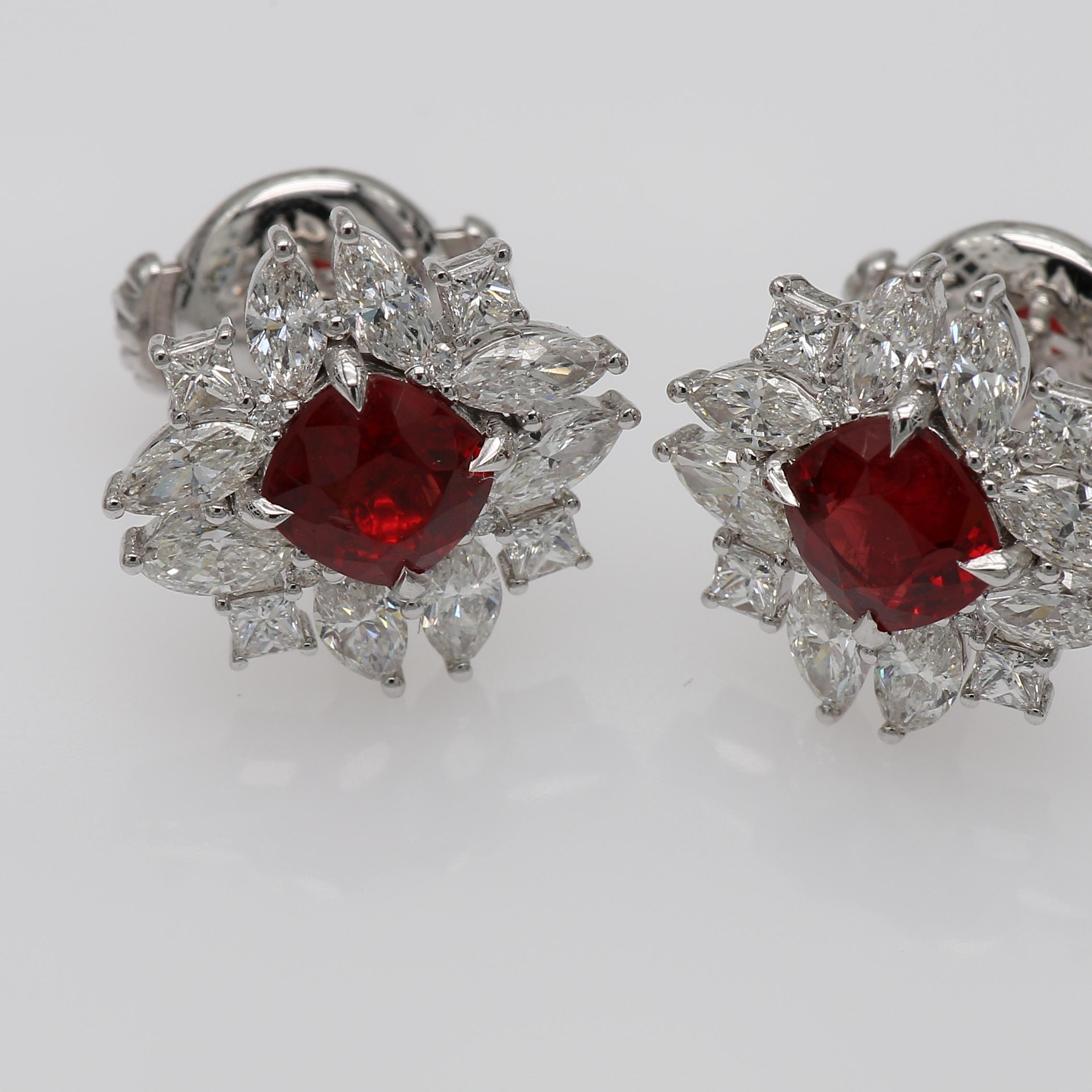 Enchanting natural Red Spinel Diamond centerstones in Cushion shape surrounded with fine Marquise and Princess shape natural Diamonds. Together they create two beautiful flower shaped Studs. The Studs are light weight and securely fastened with an