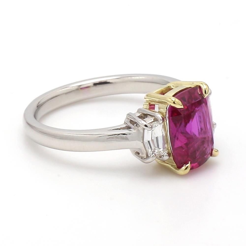 Platinum and 18K Gold Ring with Ruby and White Diamonds

This elegant ring features a stunning cushion-cut red ruby, flanked by shield-cut white diamonds. The combination of vibrant red and sparkling white creates a striking visual appeal. Crafted