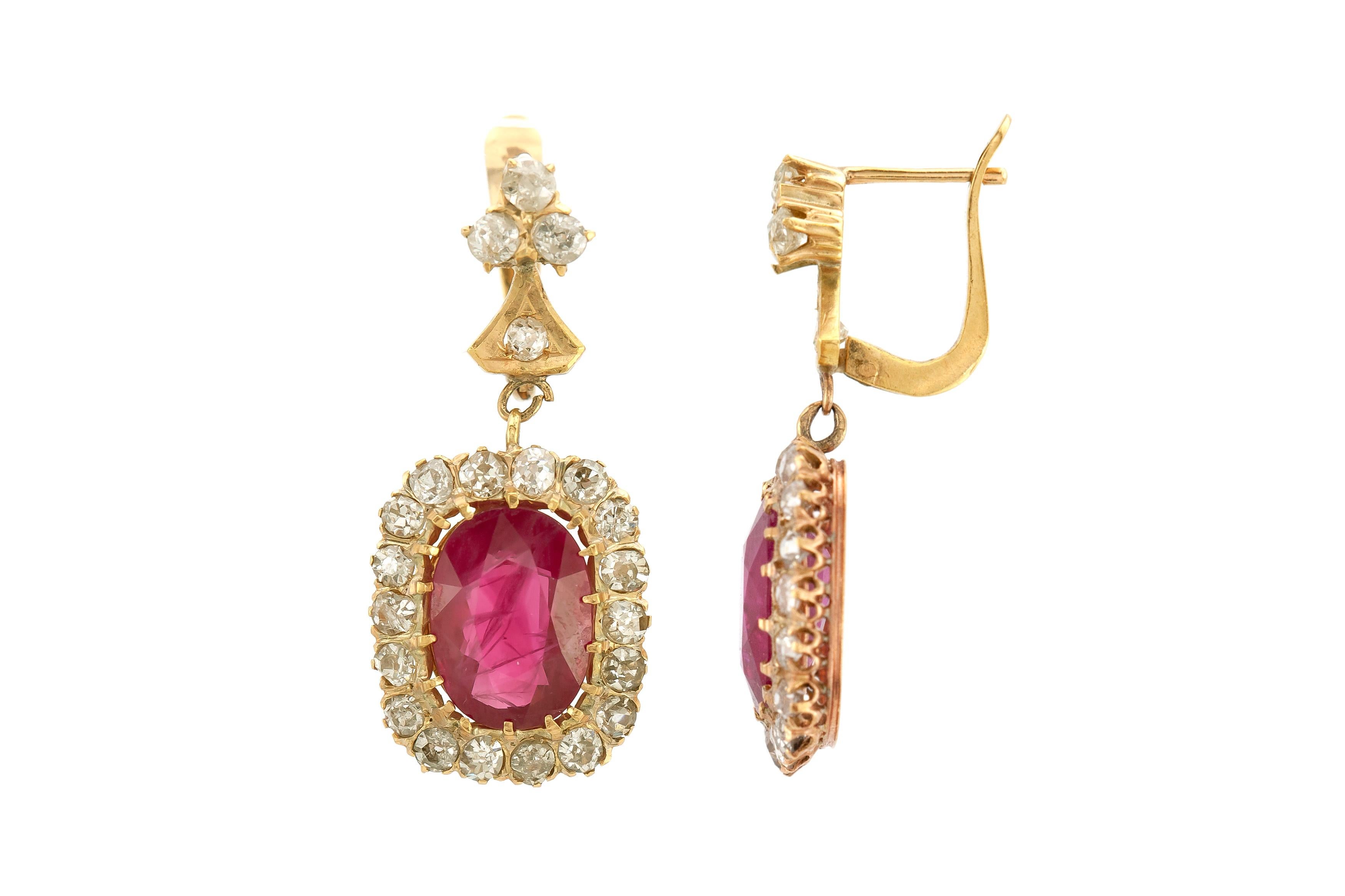 The earrings are finely crafted in 18 k yellow gold with the center stone ruby weighing approximately total of 6.19 carat. One ruby is 3.08 carat while the other is 3.11 carat. Diamonds weigh approximately a total of 3.50 carat.

