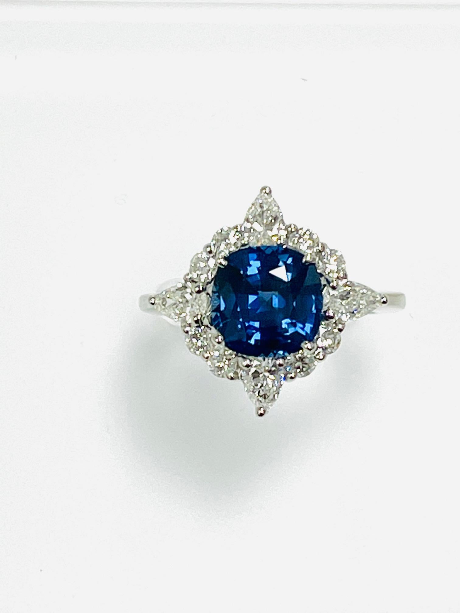 3.92 Carat Cushion cut Sapphire, heat , certified CDc lab, set in platinum ring along with 1.50 ct round and pear shape diamond.