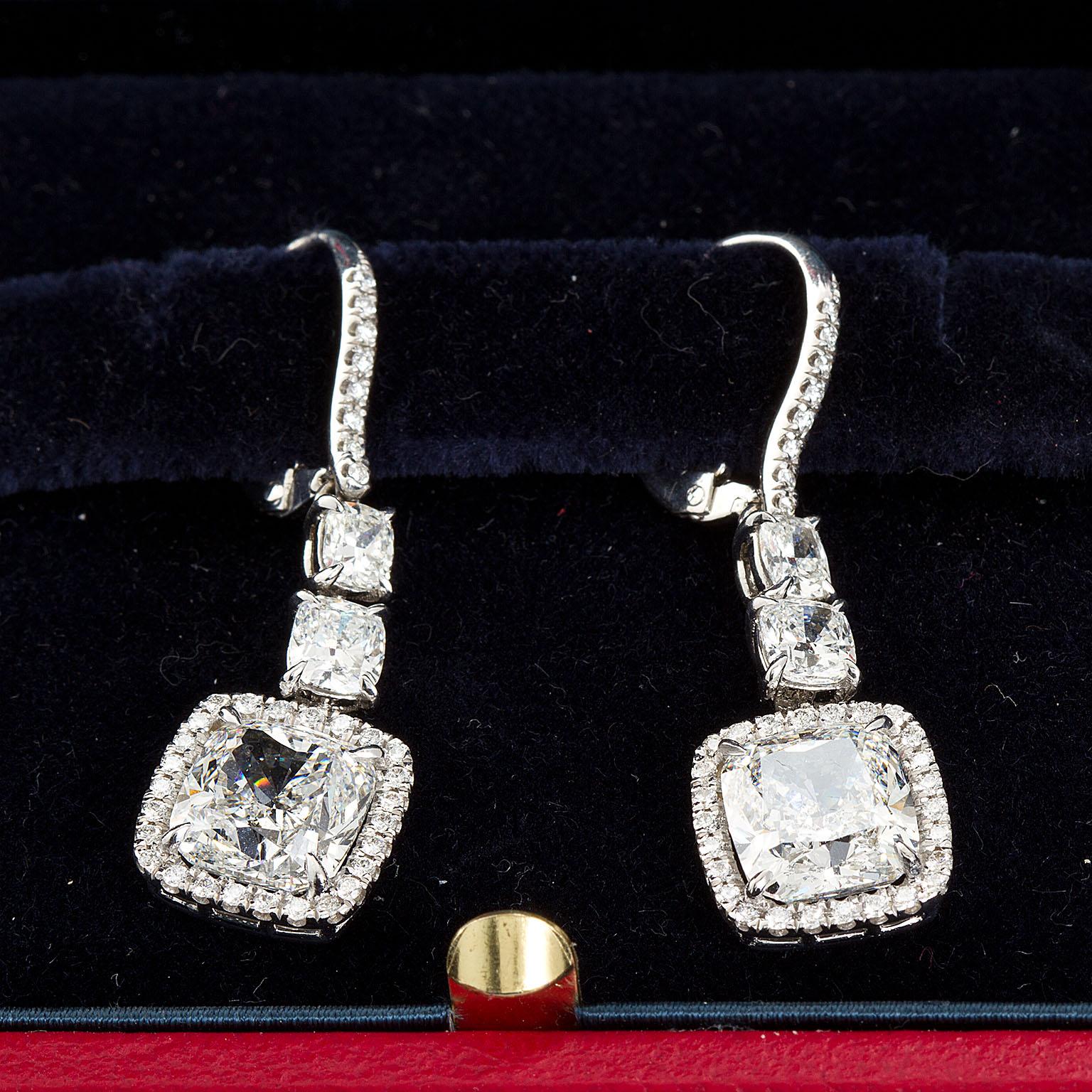 Pair of fine diamond dangle earrings set with a 4.00 carat each Cushion shape diamond, suspended from platinum gooseneck leverbacks and two (each) graduated Cushion shape diamonds.
Main diamonds are 4.02 ct. G color VS1 clarity and 4.01 carat F