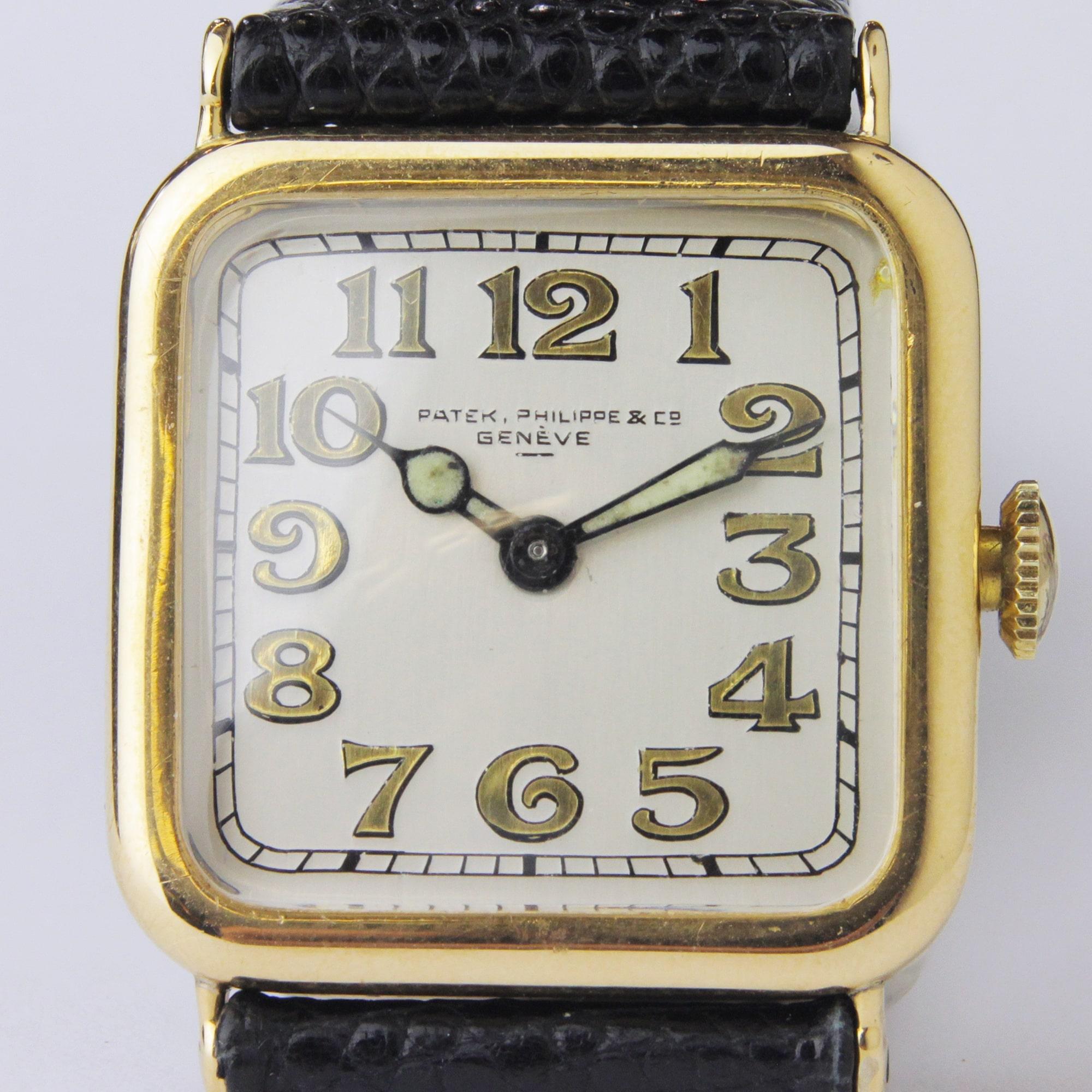 A scarce Art Deco wristwatch by famed Swiss horologists, Patek Philippe. The piece is crafted from 18 karat yellow gold in a cushion shape, has an enamelled dial and luminescent hands. There are rubbed Patek Philippe markings to the rear which are