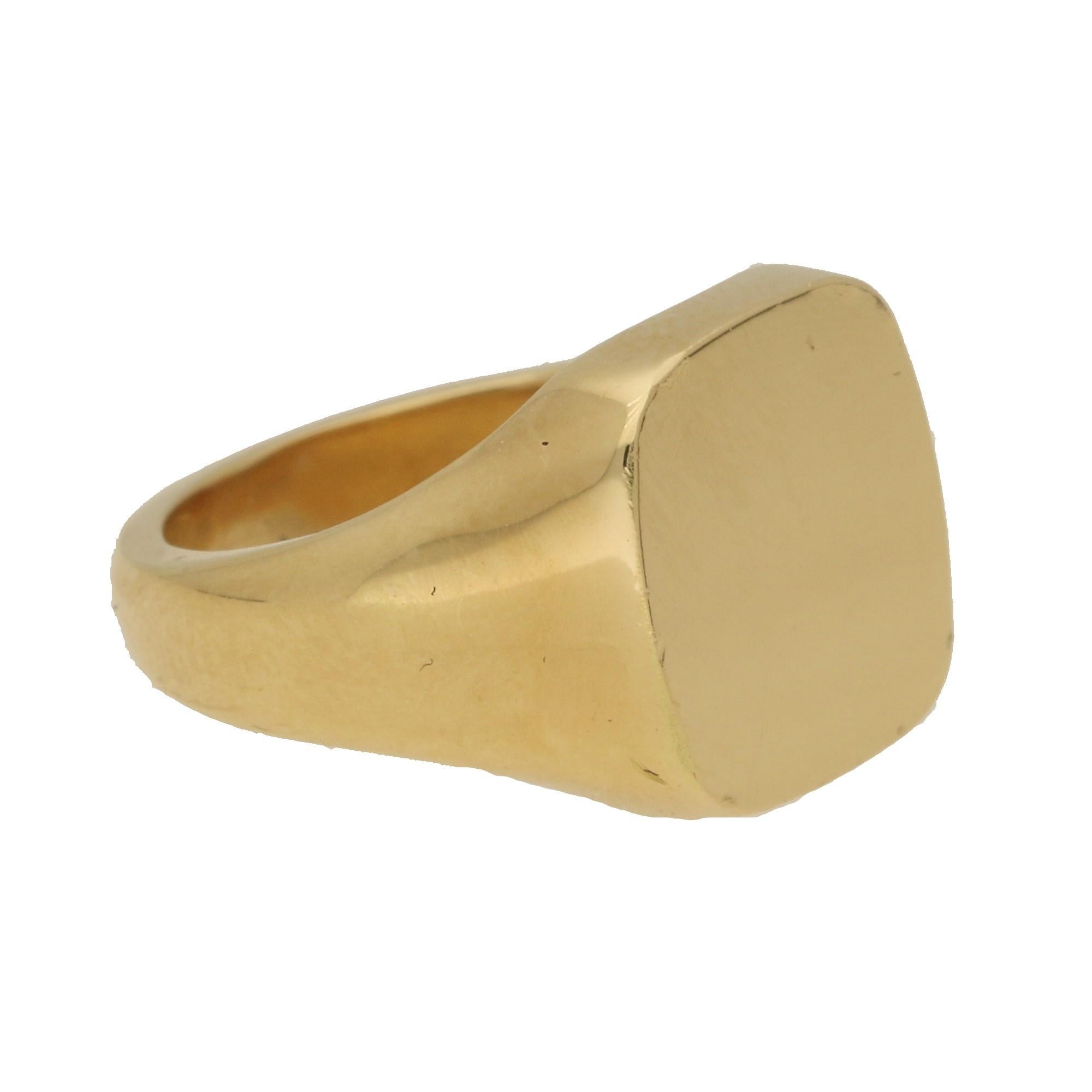 A classic cushion shaped signet ring made of solid 18k yellow gold.

The ring head measures approximately 11 x 11.5mm and is left bare so that the wearer has the option to customise it in the future. Typically signets are decorated with a family