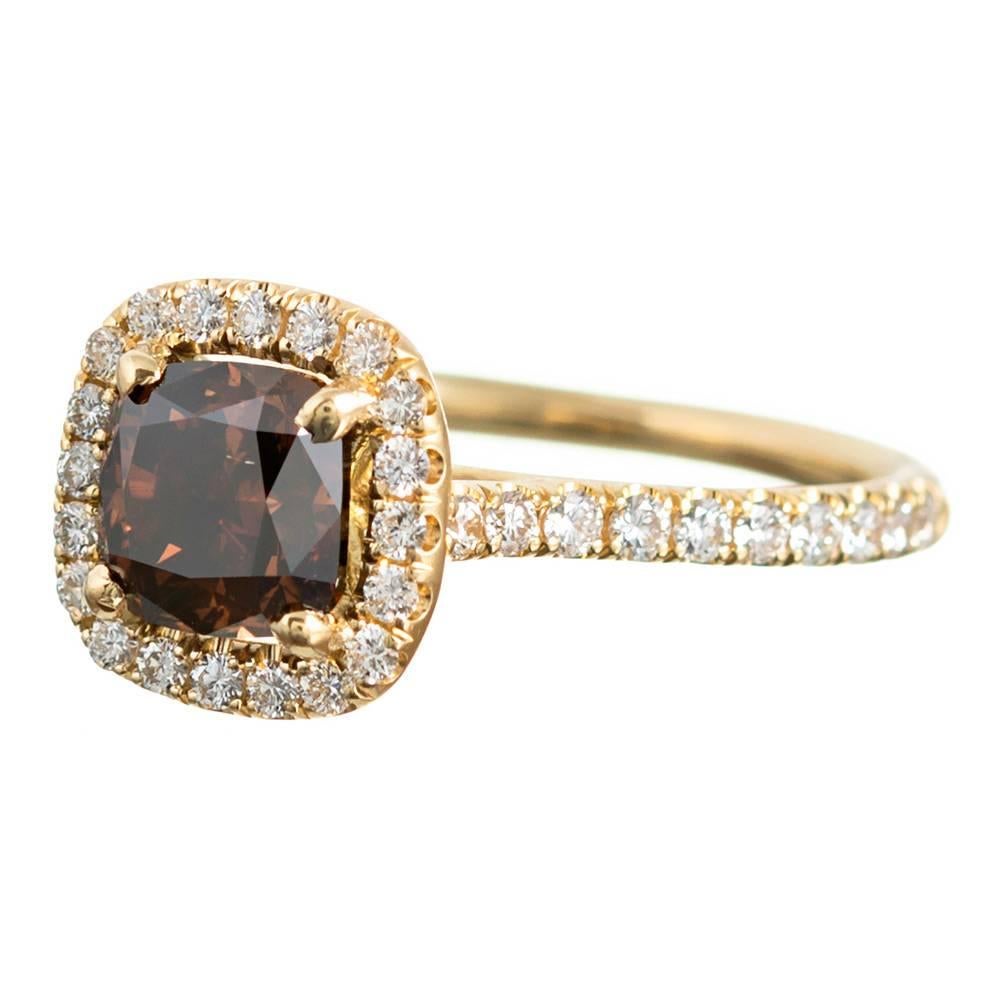 For she who desired something timeless, yet uncommon, this classically-styled ring will be your forever favorite. Set in the center of an 18 karat yellow gold mounting and framed in a halo of .46 carats of brilliant white diamonds grading G color