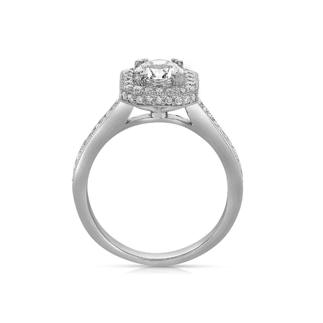 Ladies' 14k White Gold Diamond Engagement Ring. Cushion shaped halo gives the round center diamond an elegant look with a vintage flair. Exquisite pave set diamonds run on both sides of the ring. Round center diamond is included, 0.79 ct weight, H