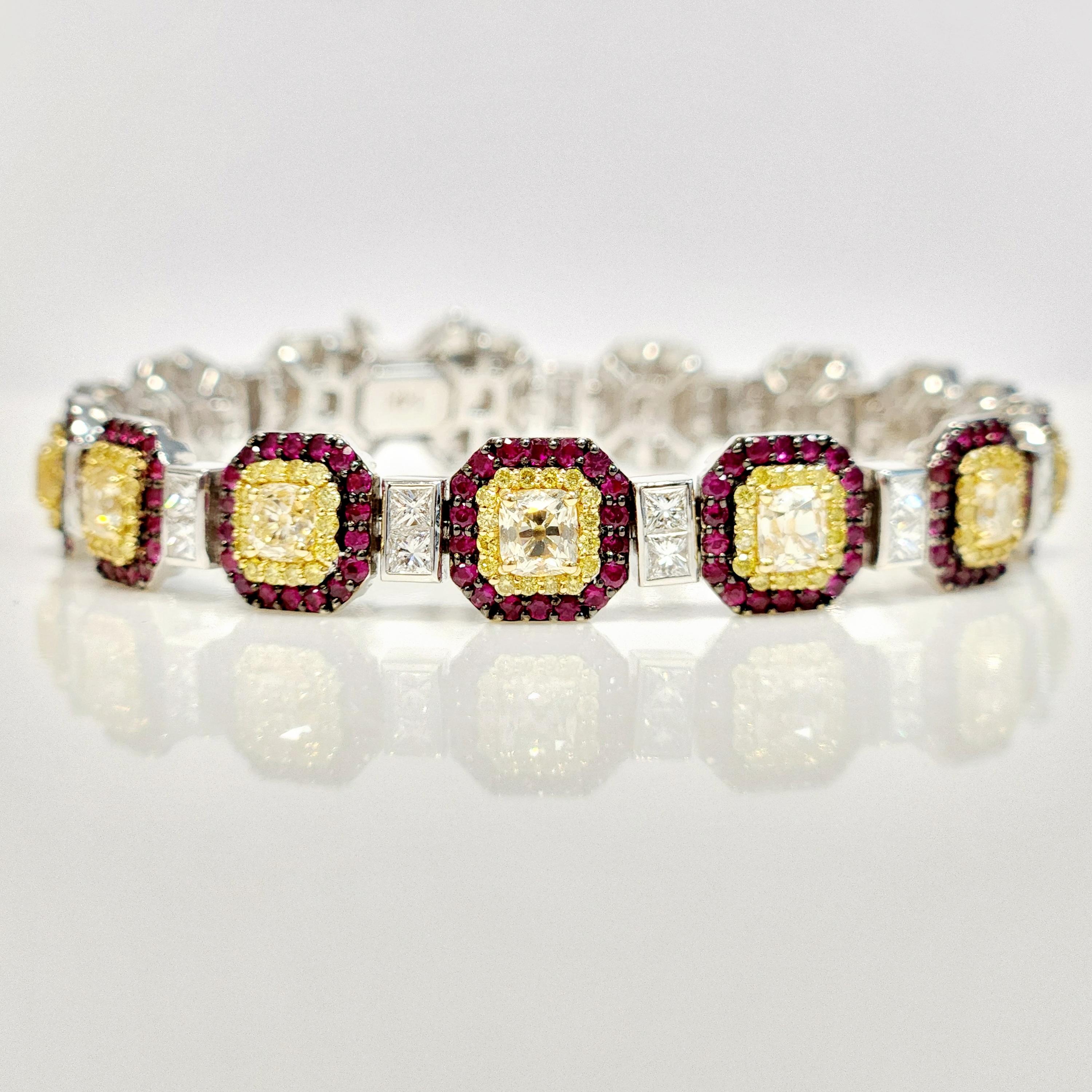 Elevate your style with the striking beauty of the Cushion Shaped Yellow Diamond and Red Ruby Line Bracelet. This exquisite piece features 4.71 carats cushion-shaped yellow diamonds as the focal point, each encircled by a halo of dazzling yellow
