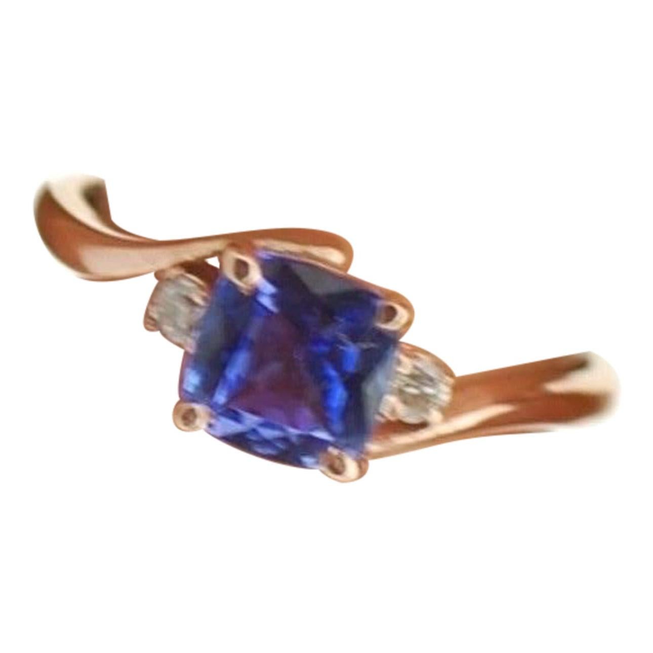 Violet Tanzanite and diamond engagement ring in 18KT rose gold, so stunning and so vibrant!!! Made in size 7 and can be re-sized to any size. This beauty has 1 ct cushion and two diamonds weighing about 0.20 carats with VS clarity and F color. The