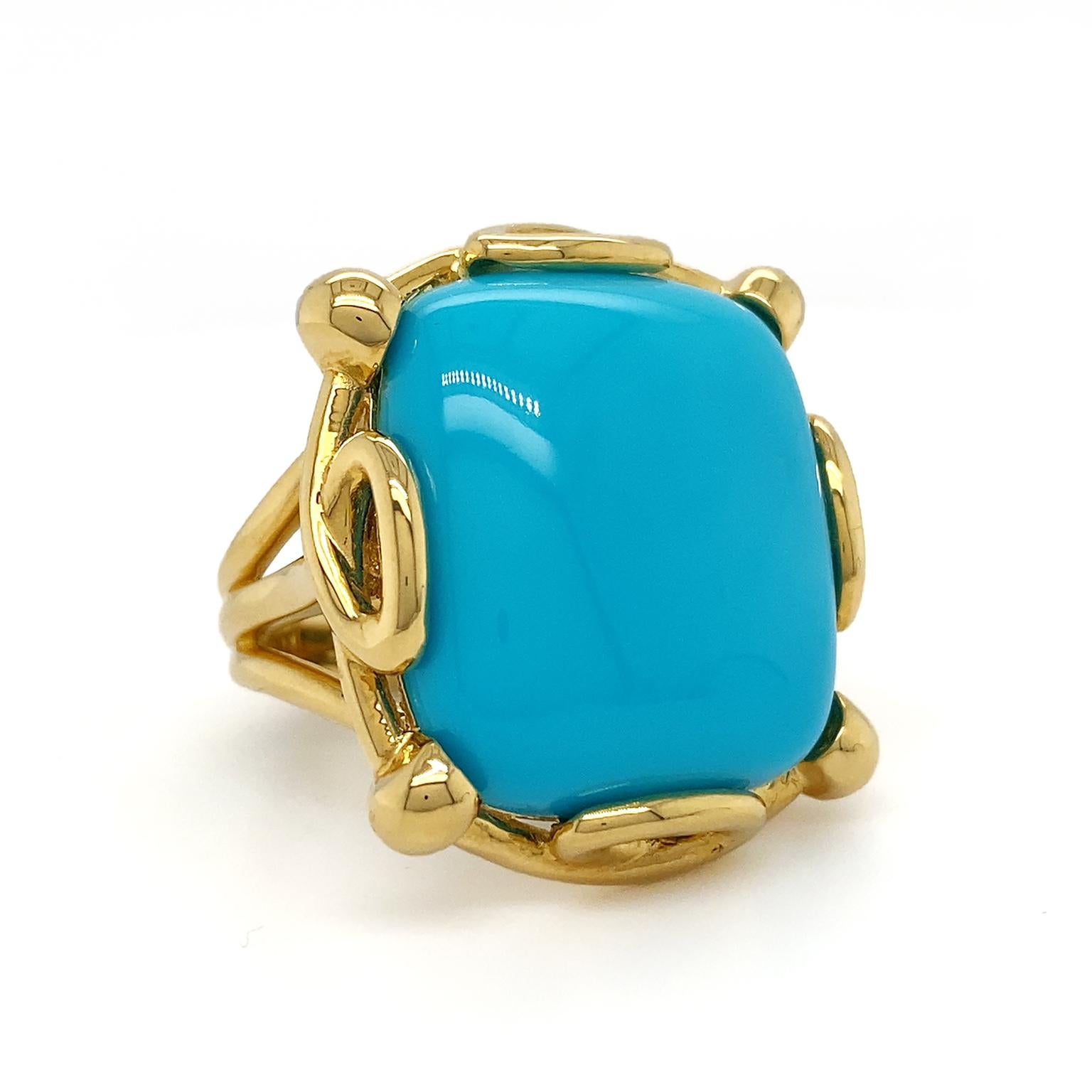 Turquoise displays its vibrant cool toned hue in this ring. Carefully selected for its opaque beauty, the carved cabochon of the gem is set by a pattern of 18k yellow gold loops and prongs. The gold also further accentuates the distinct shade of the