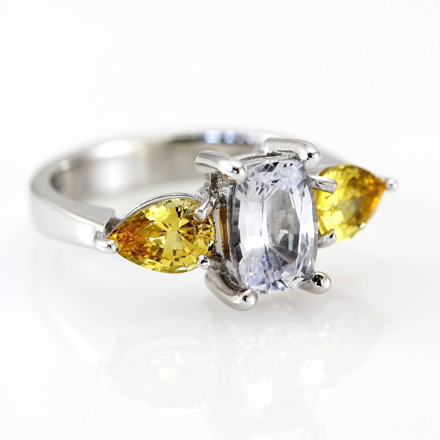 Bianca & Giallo Zaffiro Ring

This gorgeous dress ring in 18ct white gold is set with a lovely colourless sapphire in between a pair of eye-catching fancy yellow sapphires. 

Cushion faceted sapphire: colourless, 1.93ct

Pear faceted sapphires: