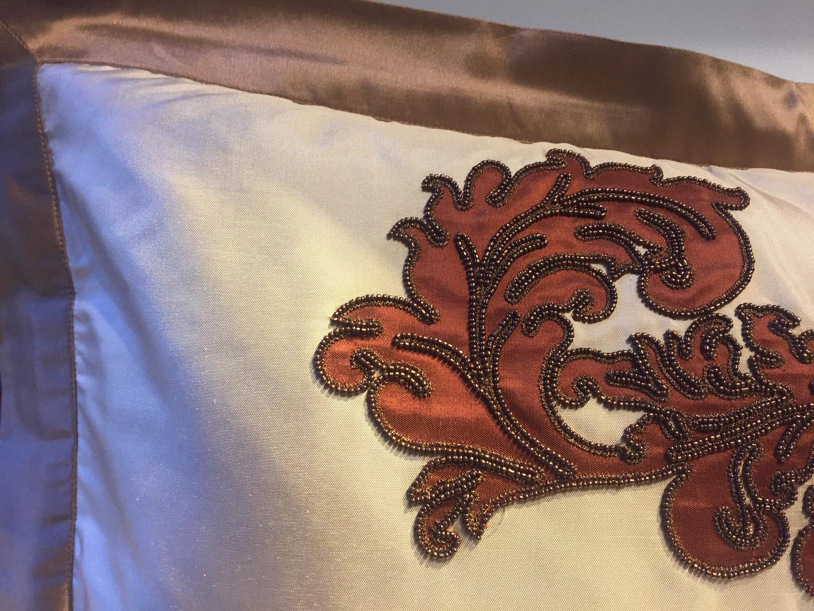 Cushions cinnamon silk with modern damask design hand embroidery and appliqué work with beading color copper
Oxford trim detail 4cm wide
Cotton lining
Feather pad
Size: 54 x 38 cm includes trim.
