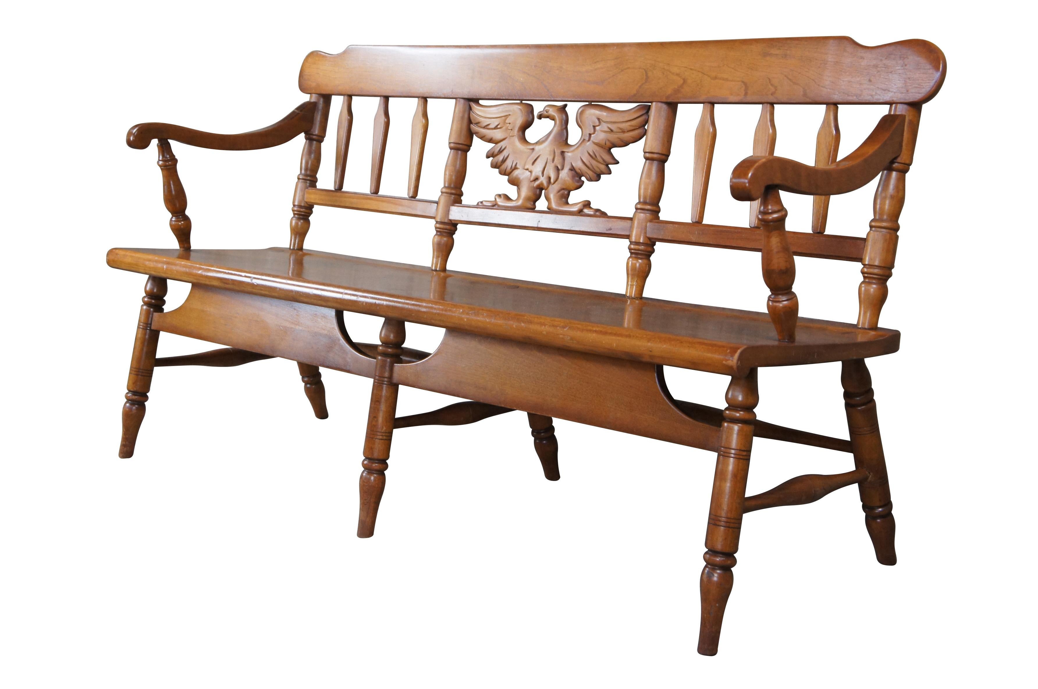 Vintage Cushman Colonial Creations settee bench.  Made of maple featuring slatted back with sloped arms and carved eagle.  # 6031.

The H.T. Cushman Manufacturing Company was founded in 1886 and spent close to 100 years building furniture in