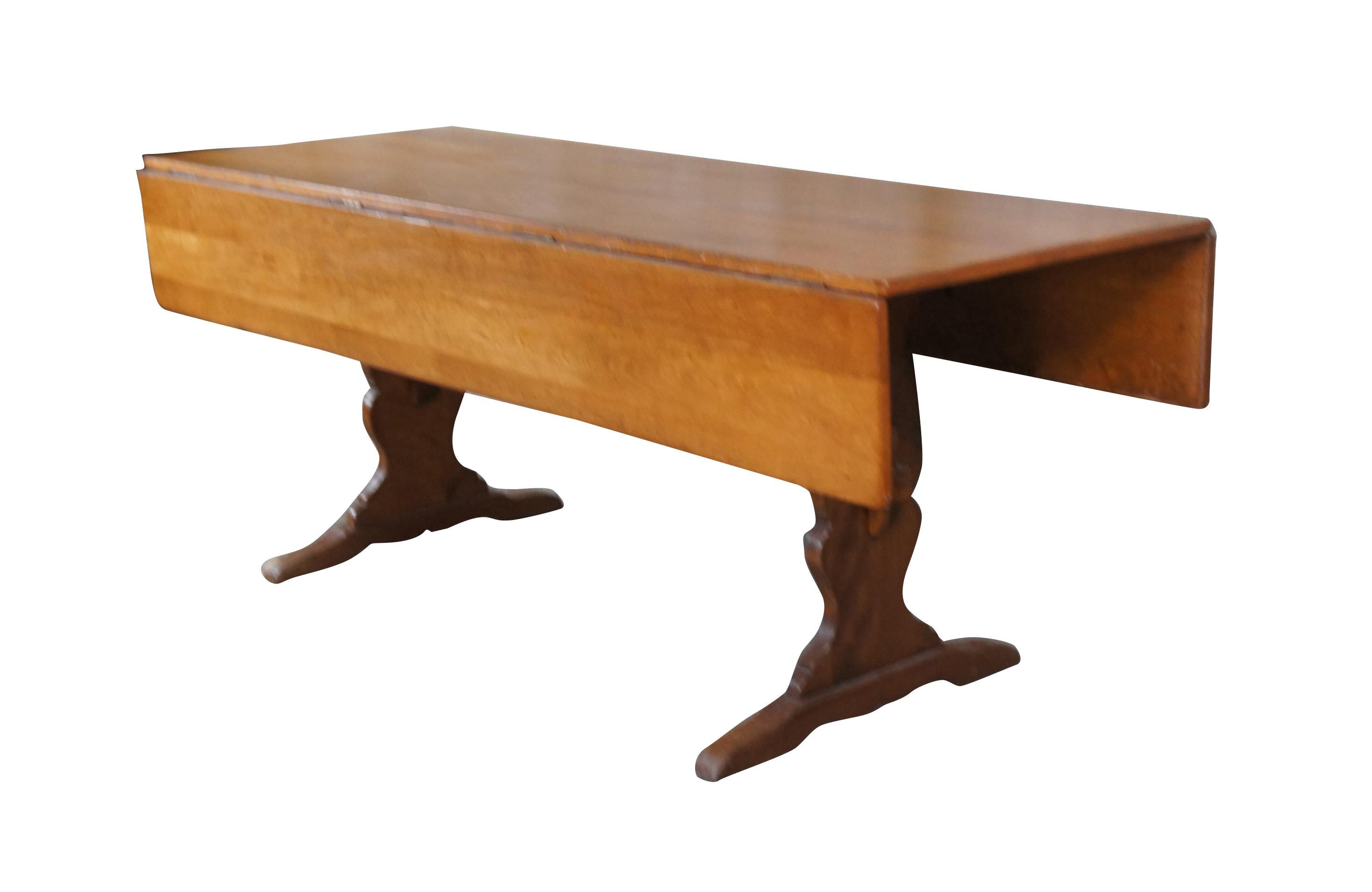 Vintage Cushman Colonial Creation drop leaf country farmhouse dining table.  Made of rock maple featuring rectangular form with two large long drop leaves over a serpentine trestle base.  A Genuine Cushman Colonial Creation made in Bennington
