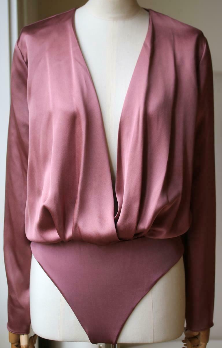 This bodysuit is made from a languid silk-charmeuse and has a plunging wrap-effect neckline and elasticated waist. Antique-rose silk-charmeuse. Snap fastenings at base. 100% silk; fabric2: 68% viscose, 32% polyester. 

Size: Medium (UK 10, US 6, FR