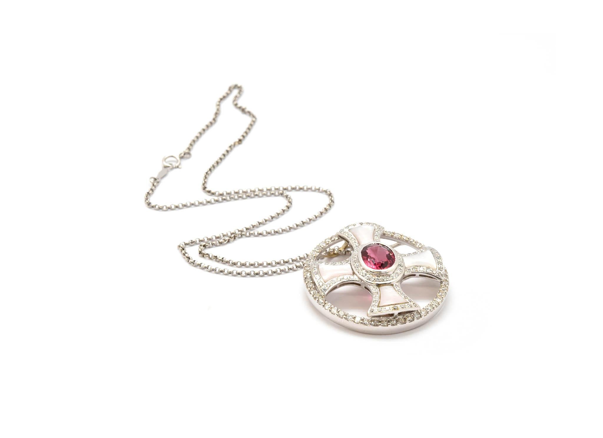 This necklace was custom made in 14k white gold. The pendant features a stunning oval-cut tourmaline that weighs approximately 1.75 carats. The tourmaline is accented by a bezel of diamonds that extends to the edges of the piece as well. The