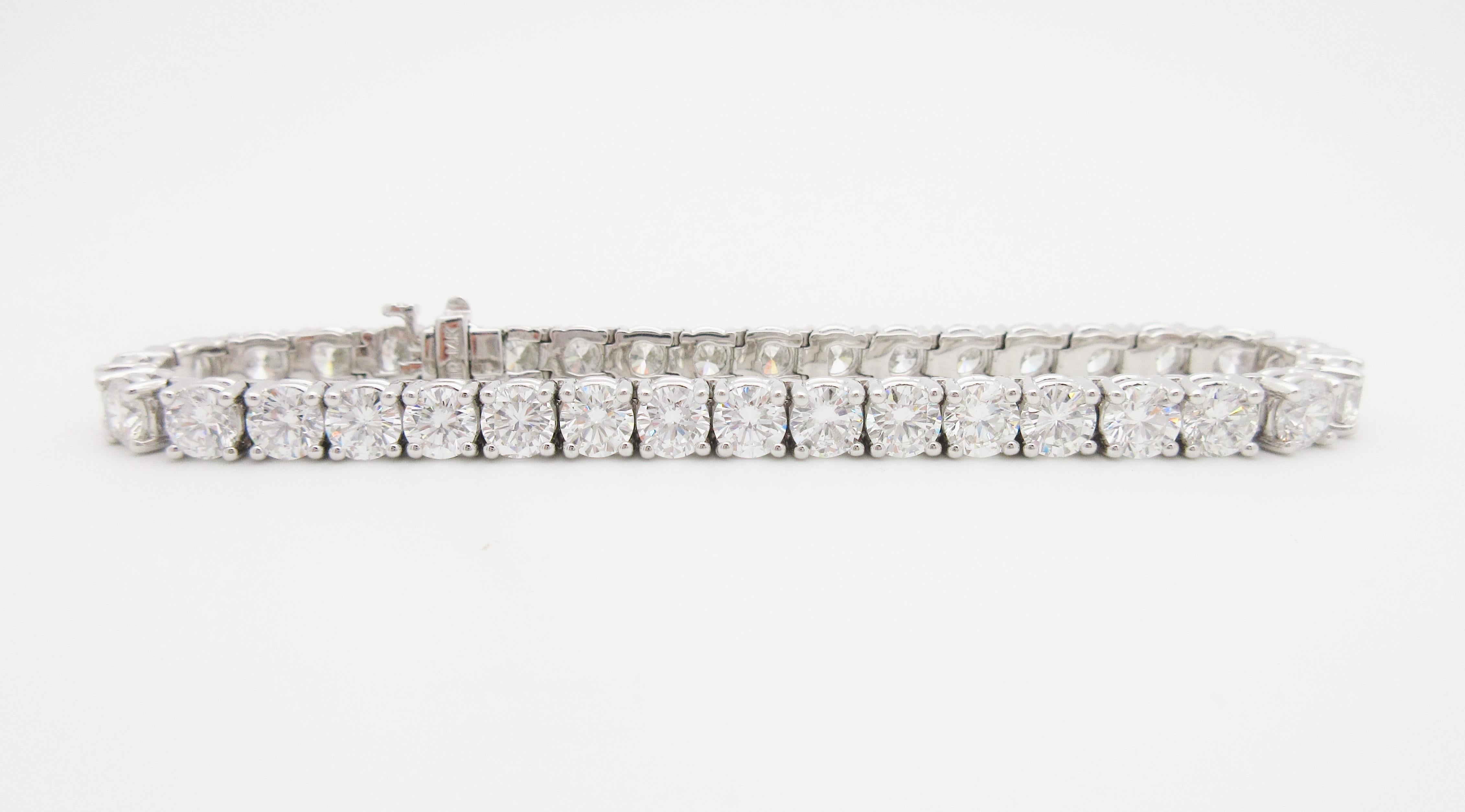 This luxurious tennis bracelet is a custom-made statement piece.

The bracelet shines with 36 hand-selected, round brilliant diamonds. Each bright white stone weighs .40ct. for a total of 14.7cttw., which our Graduate Gemologist has graded G-H in