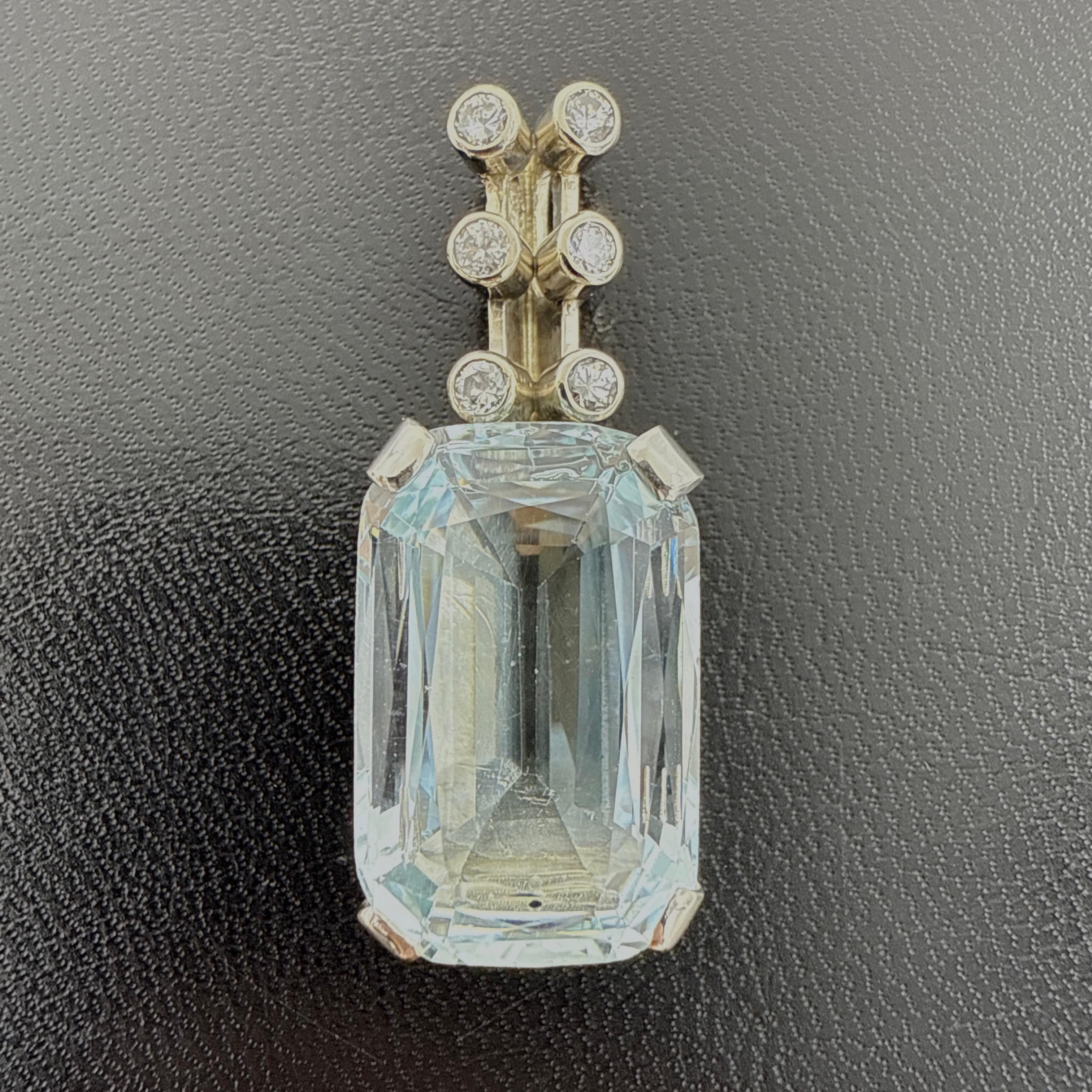 A finely crafted 14K white gold pendant featuring a large aquamarine accented by six natural diamonds. This custom-made piece is both cast and hand-finished, with a rectangular double gallery closed-back setting and a hidden round bezel-set bail.