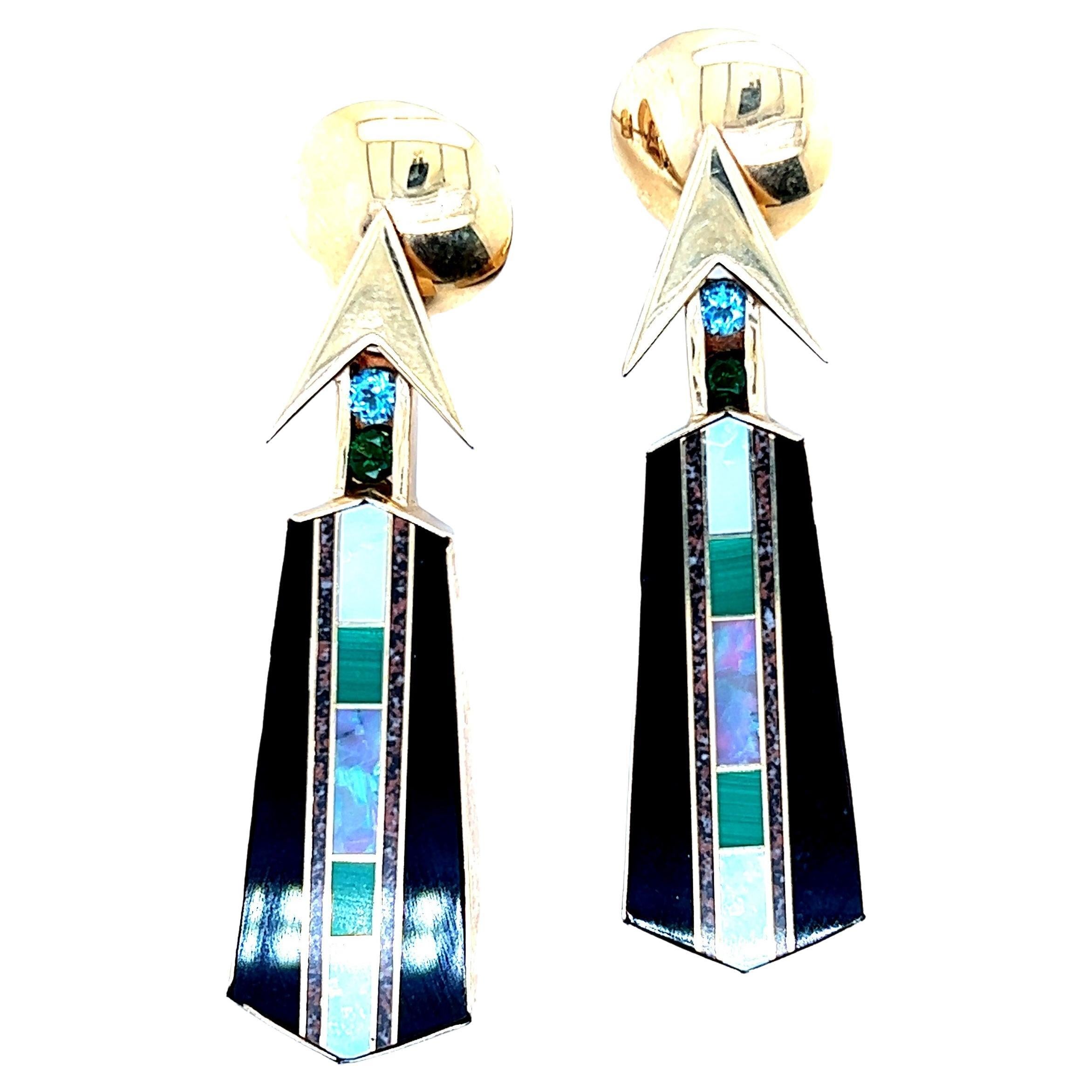 These cool Statement Earrings were custom make by Jeweler's Workshop in Madison, Wisconsin. The earrings contain inliad sections of black onyx, mother of pearl, black opal and white opal. The earrings also contain channel set blue topaz and chrome