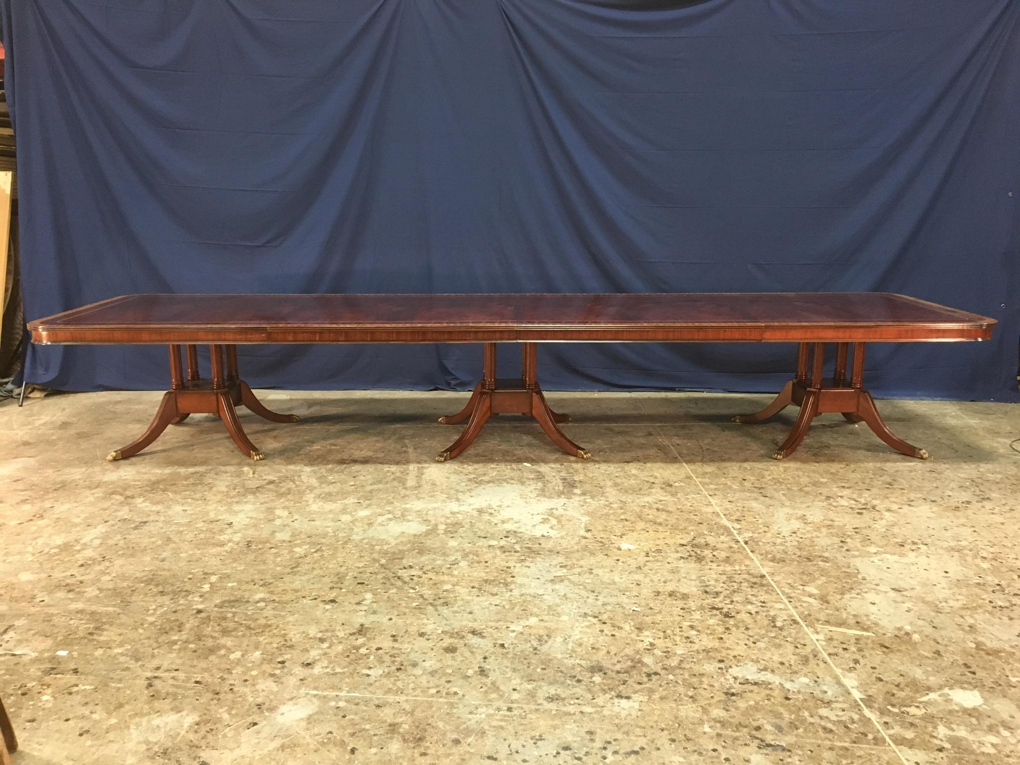 This is a made-to-order large traditional mahogany banquet/dining table made in the Leighton Hall shop. It features a field of slip-matched swirly crotch mahogany from west Africa and satinwood and santos rosewood borders from South America. It has