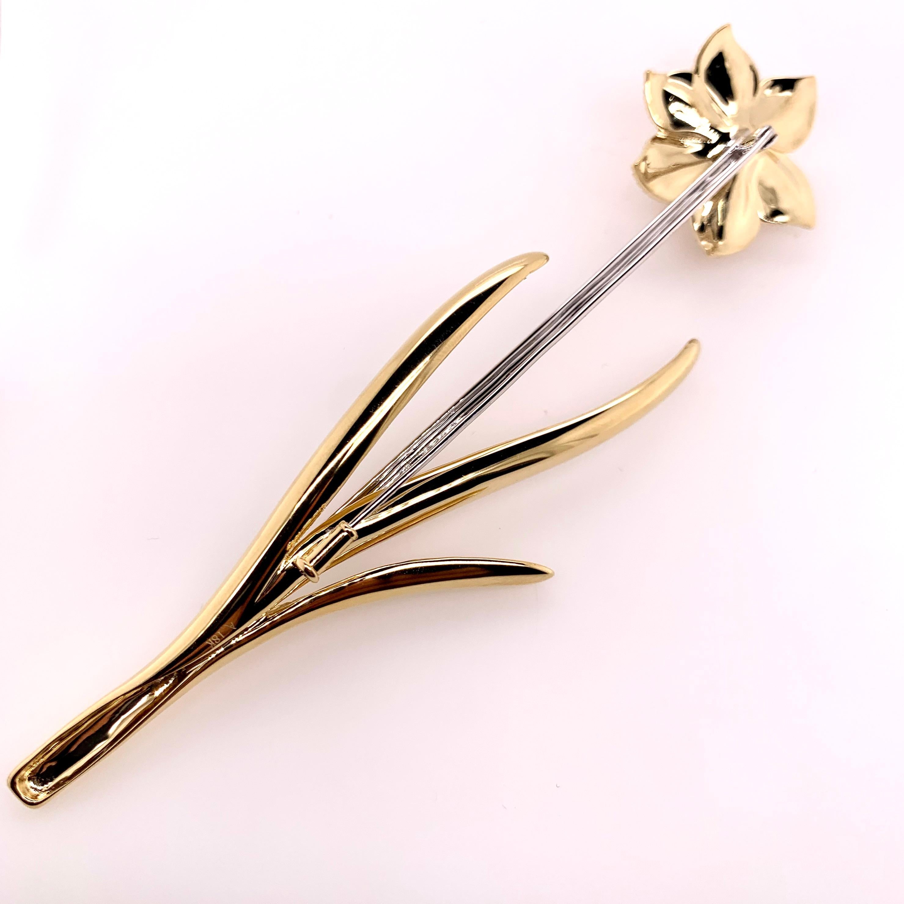 This stunning brooch was handmade and designed for all the avid flower collectors and spectators.   The tricolor 18k gold combination is stunning with the fine details involved making the bulbs and petals.  It is 5 inches in length with a stick pin