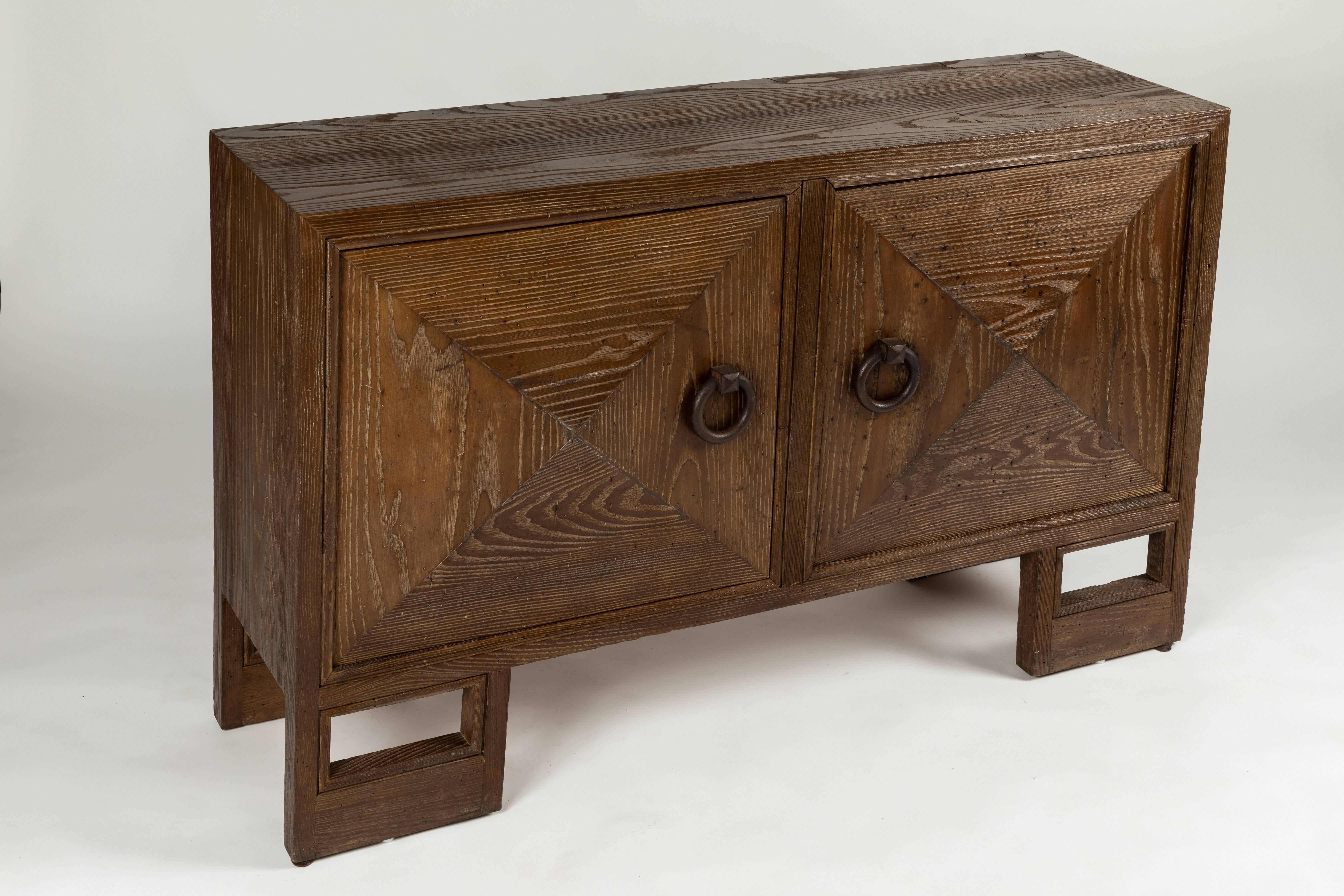 A rare and early two-door cabinet designed by James Mont. The original finish to the open grained oak is a rich smoke color. I believe the finish is original as there are no signs of refinishing...
The trapezoidal cabinet is branded on the inside