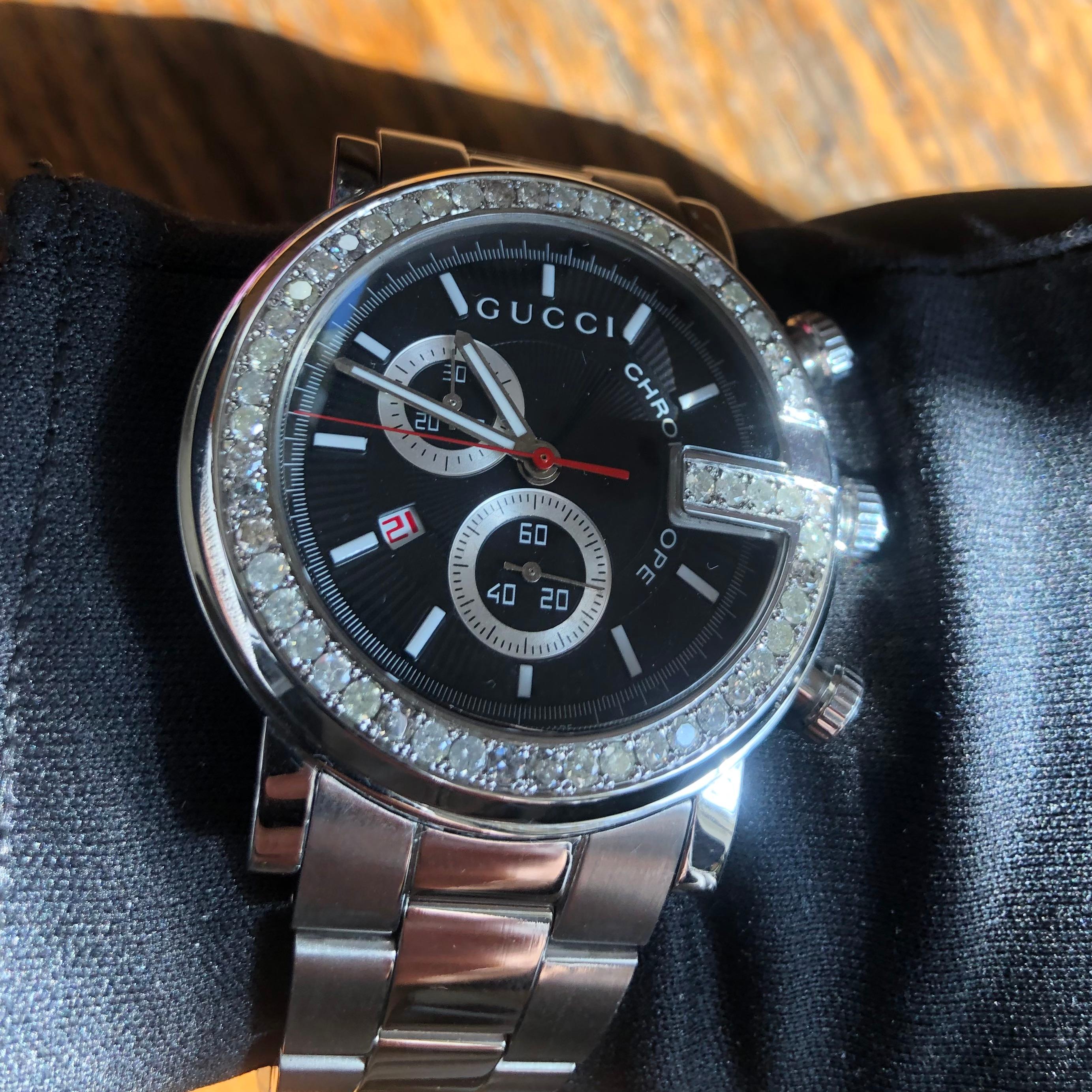 Custom Diamond Gucci 101M G Chrono Swiss Made Black-dial 44mm Watch with box and booklet papers. 

Original Gucci Bezel customized hand-set with approx. 3.00 carats of natural genuine earth-mined SI-I Diamonds. The diamonds shine beautifully in the