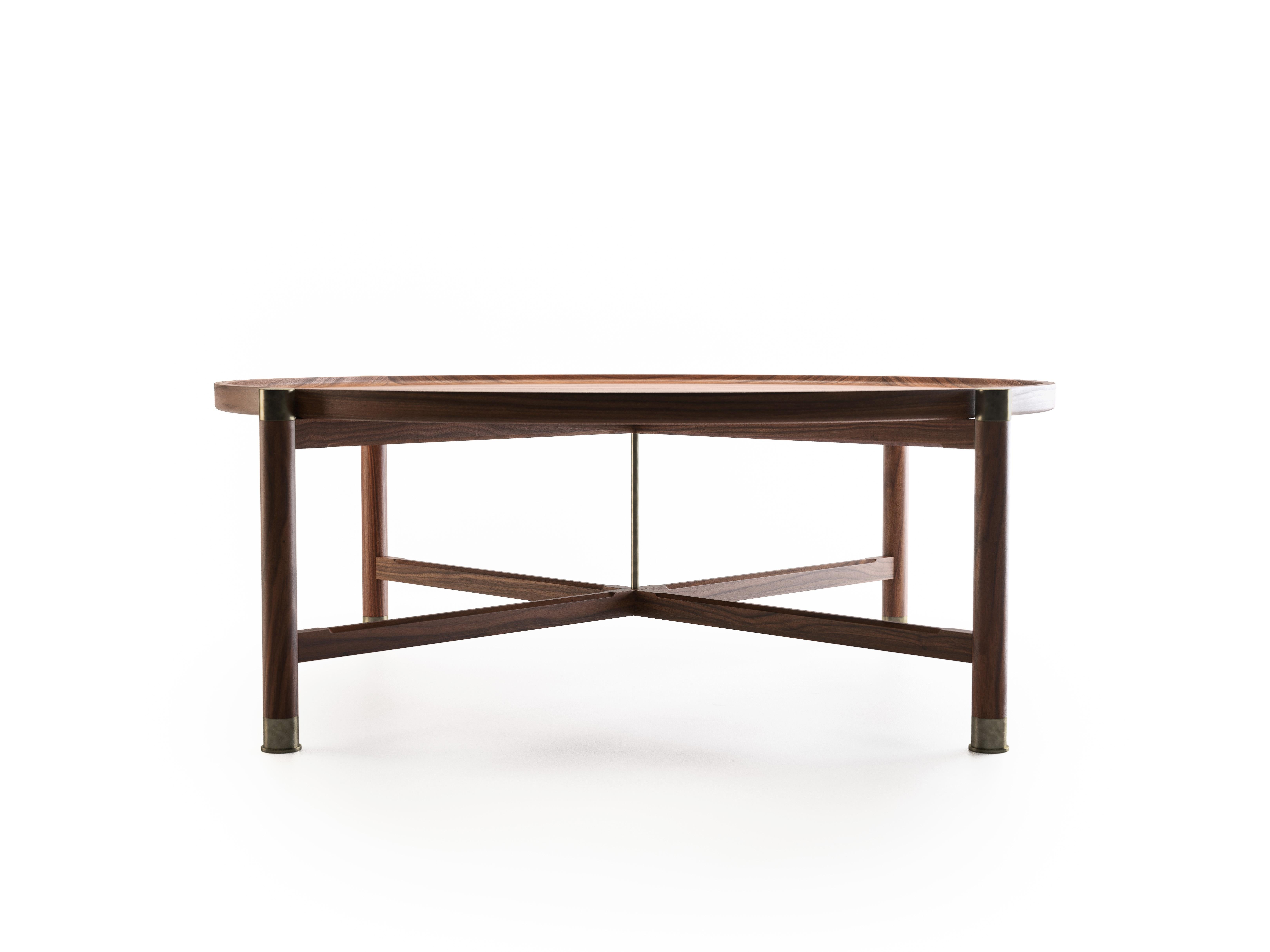 The Otto coffee table is a handsome, generously proportioned table with a timeless form.
Available in walnut or oak, it features a round coupe top, substantial antique brass fittings, and sleek chamfered stretchers. The epitome of understated