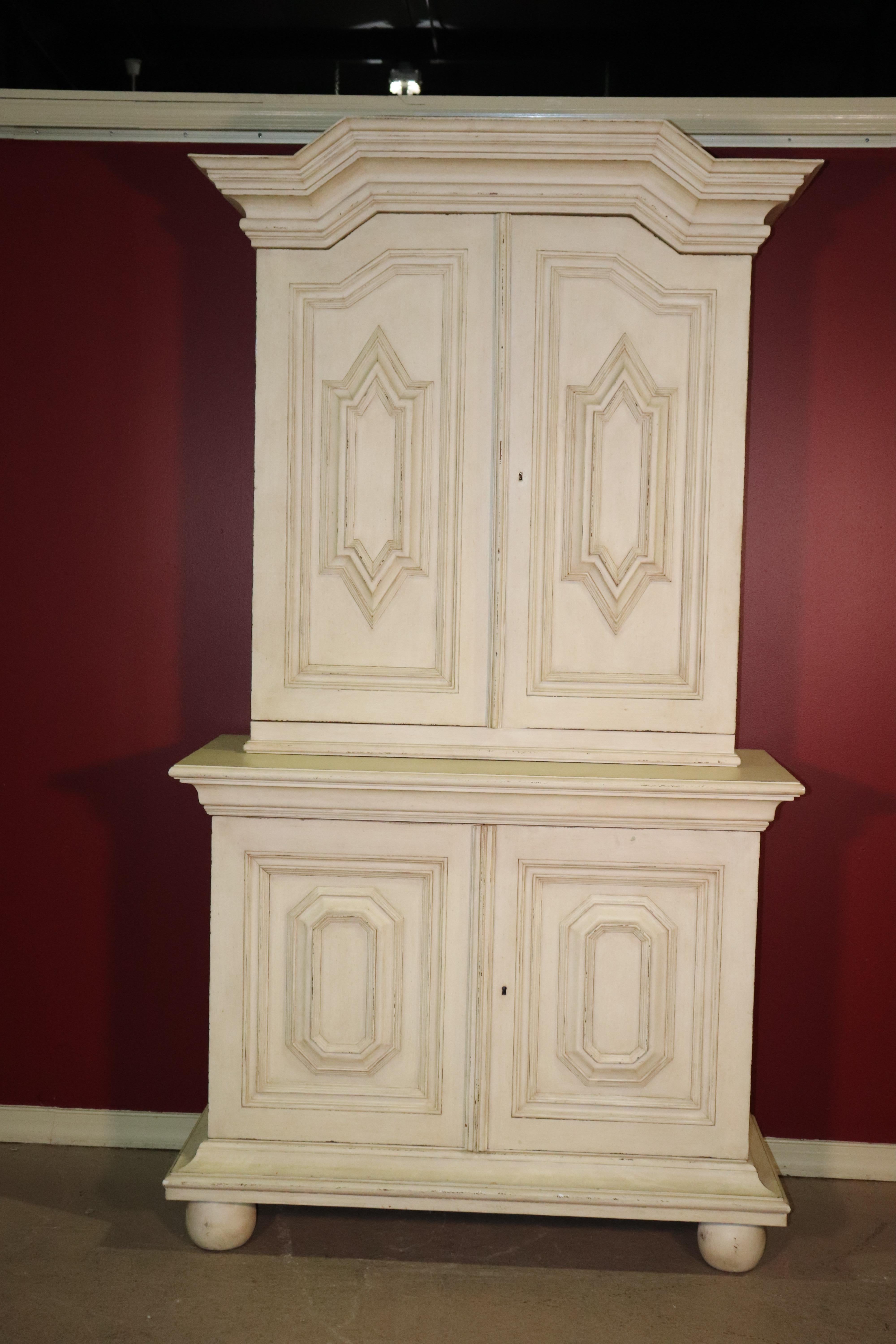 This is a gorgeous antique distressed painted Gustavian armoire or wardrobe. The cabinet is made of a solid hardwood and has removable shelving and a great distressed white finish. The cabinet is not especially old at 50 years, but looks antique.