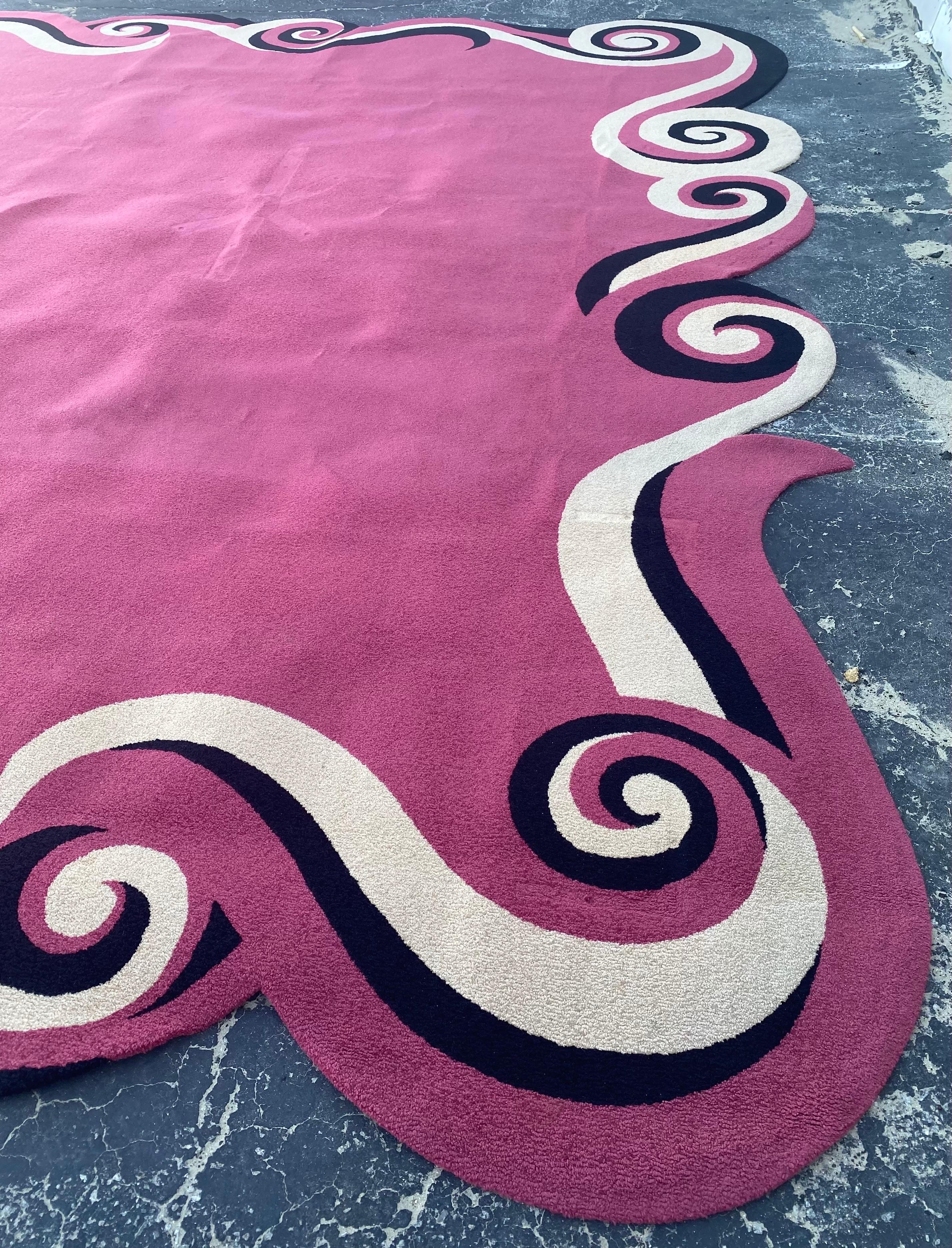 This area rug was custom made and is one of a kind. It was designed for a client’s residence in a wonderful whimsical French Modern style. Beautiful swirl design borders in hot pink, black and creme color with hot pink center. Rug was made in the