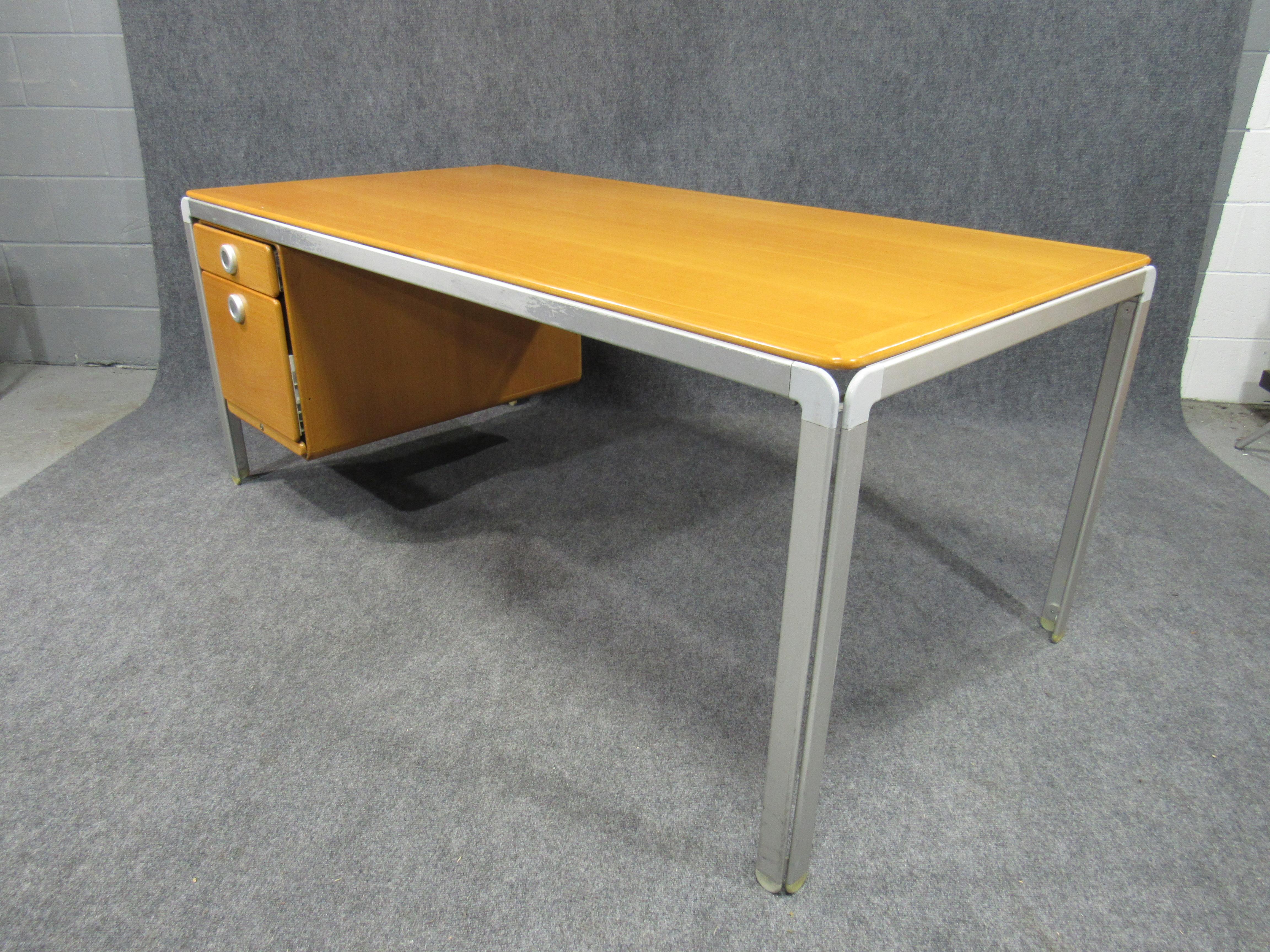 Danish architect Arne Jacobsen designed this modern writing desk in conjunction with his architectural design for the Danish National Bank, which was completed in 1970. The desk, made of an aluminum frame, linoleum top and mahogany drawer modules,