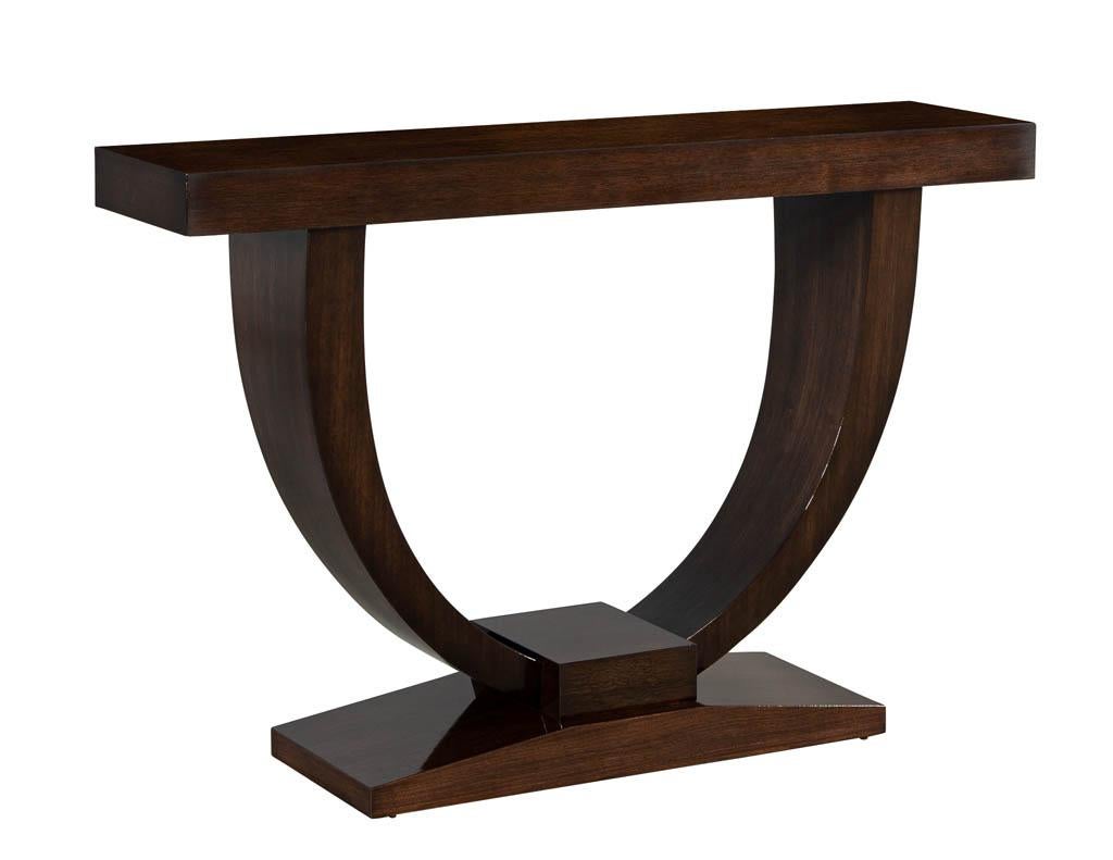 Custom Art Deco inspired modern walnut console table. This Art Deco style console table is absolutely gorgeous. With a large u-shaped base and pedestal. This console is a work of art and the perfect statement piece for entrances and hallways.