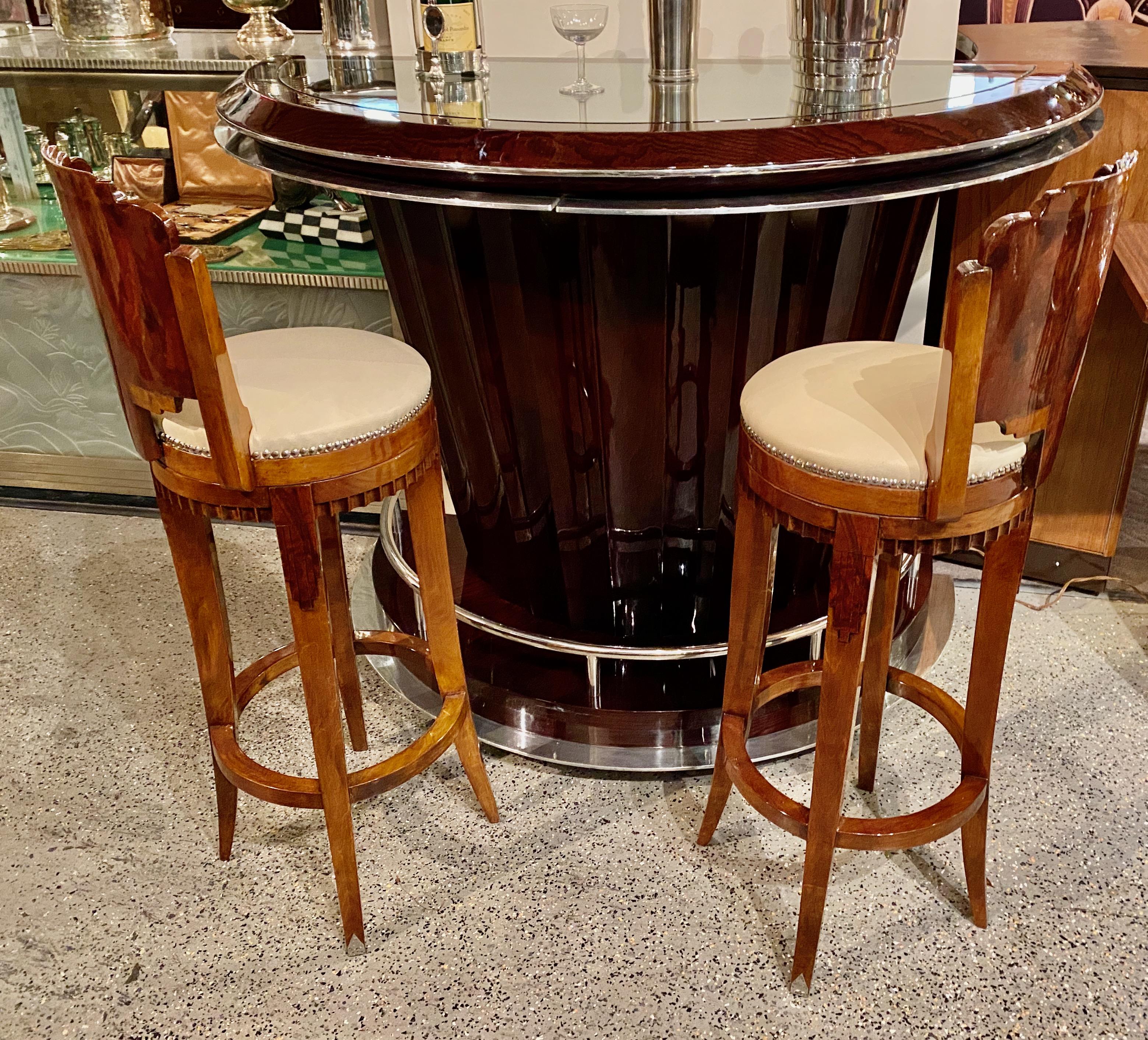Custom Art Deco swivel wood barstool using exotic woods. Quality materials: French nails used for cream leather upholstery, subtle contrasting woods pronounce some of the design details with the magnified beveled edge of intense walnut graining.