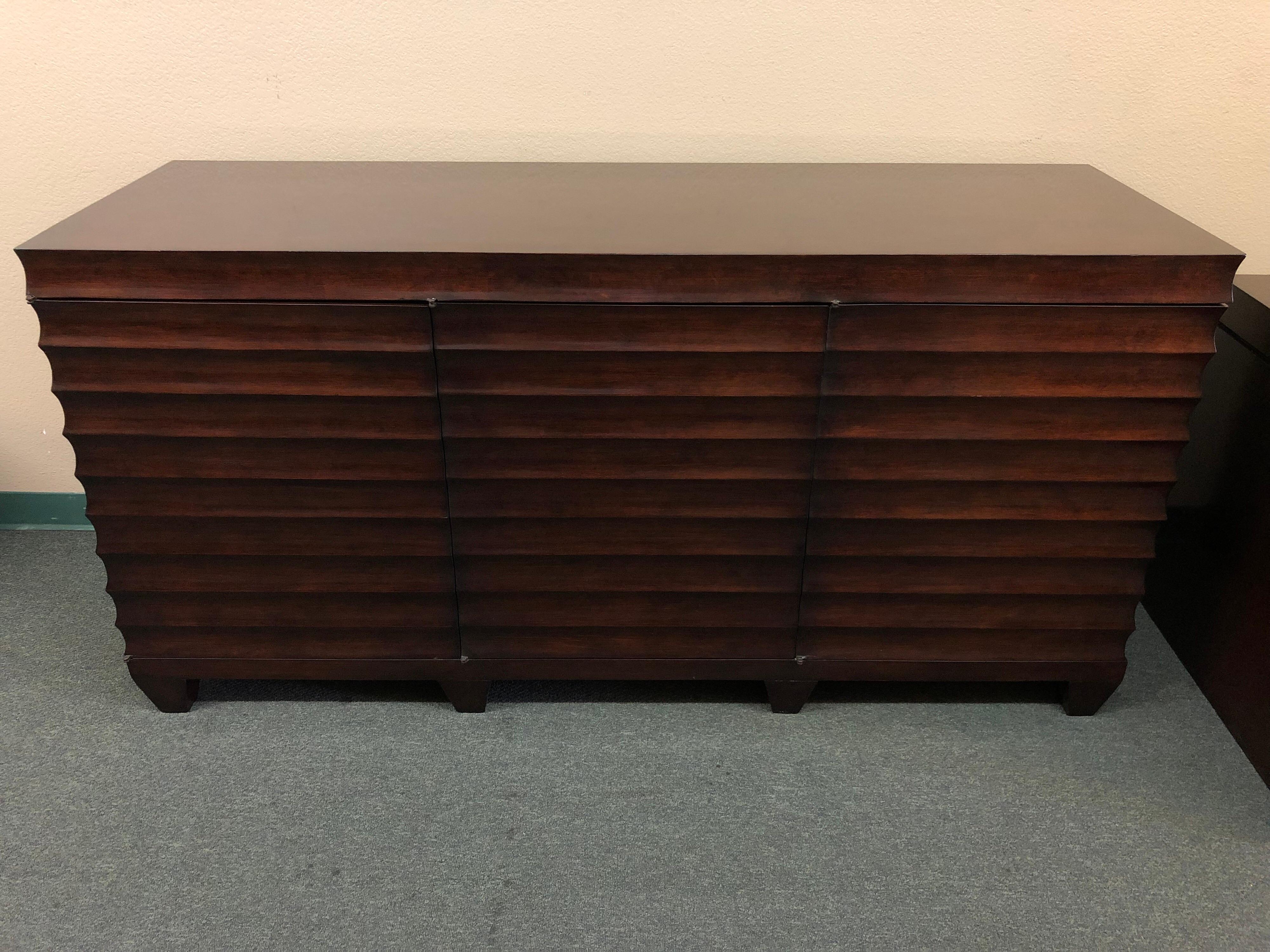 A custom media cabinet hand made by Eric Bors. Made of custom carved Alder wood with a dark ebony stain. Cabinet doors open to pull-out shelves and drawers. The unique beveled hand carvings set this piece apart.