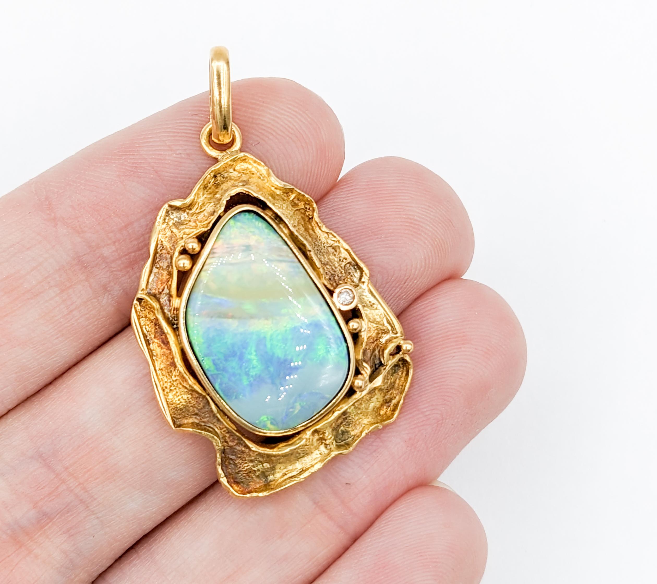 Custom Australian Boulder Opal 18kt Pendant

Introducing an exquisite piece of craftsmanship – a stunning Pendant, expertly fashioned from 18 karat yellow gold. It showcases a .02 carat Diamond that glows with brilliant sparkle. This stunning