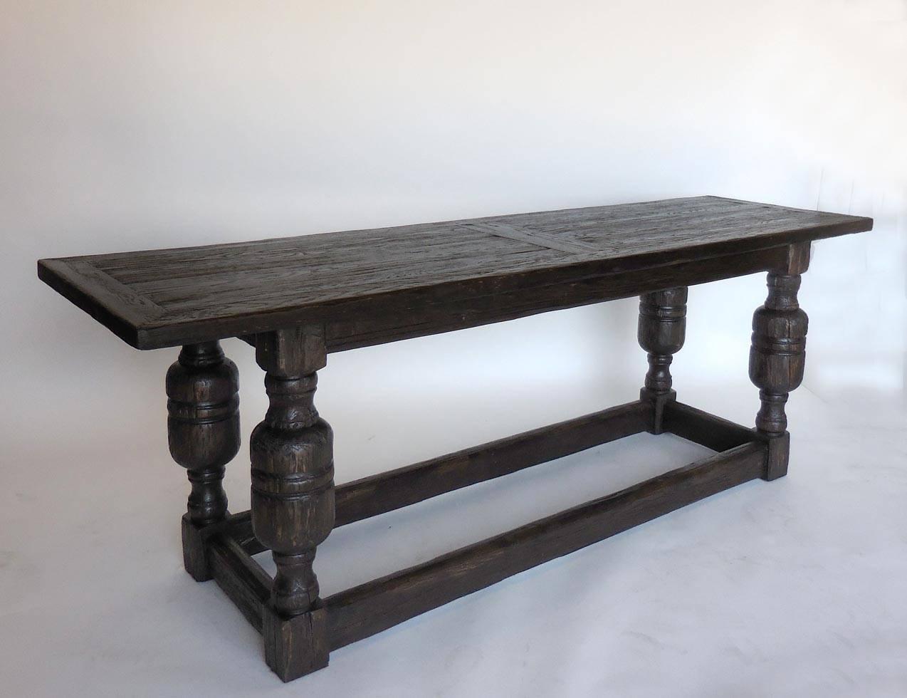 Handsome large-scale oak Baroque console. Framed tabletop and large-scale Baroque legs with four low stretchers add to the strong look. Heavily distressed oak with dark brown finish and some wood showing through for a naturally worn look. This one