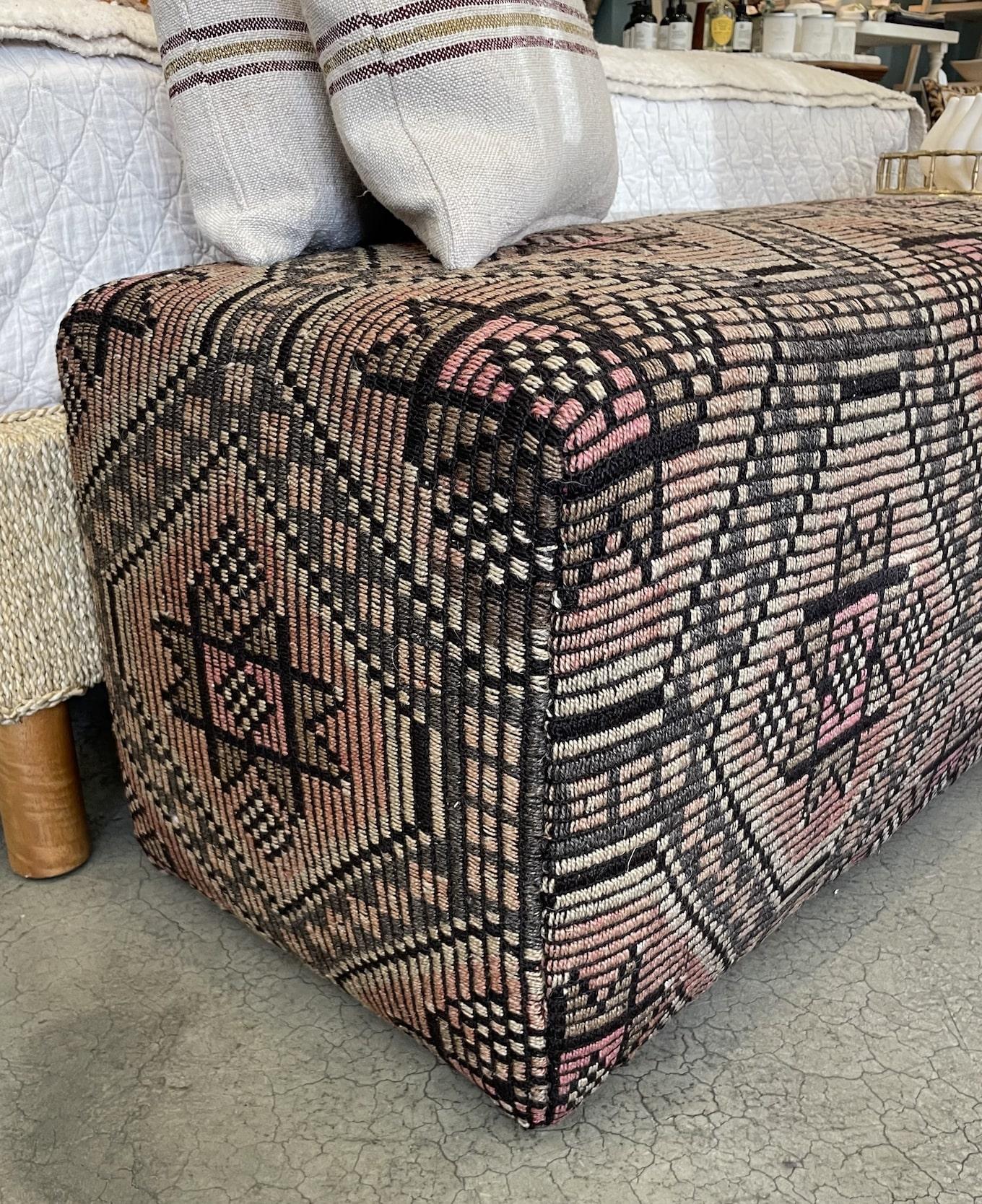 Take a seat on this fabulous custom bench that has been newly reupholstered in a handsome hand woven rug from Turkey. It's a functional and attractive addition to your room or at the end of your bed.

60
