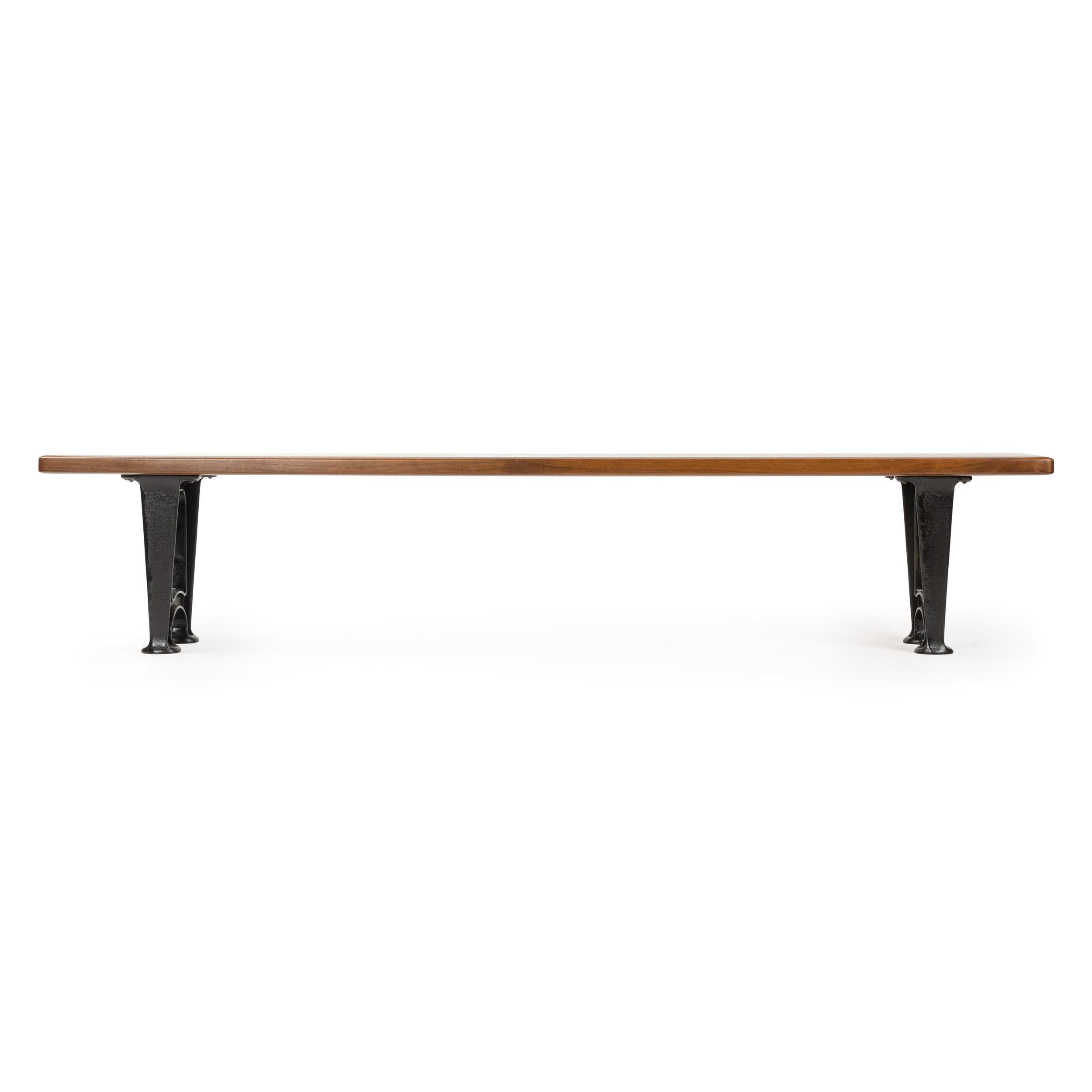 A bench with a solid walnut top on patinated cast iron legs. Custom made by the Wyeth Workshop in NY. Also available in custom lengths, woods and finished.