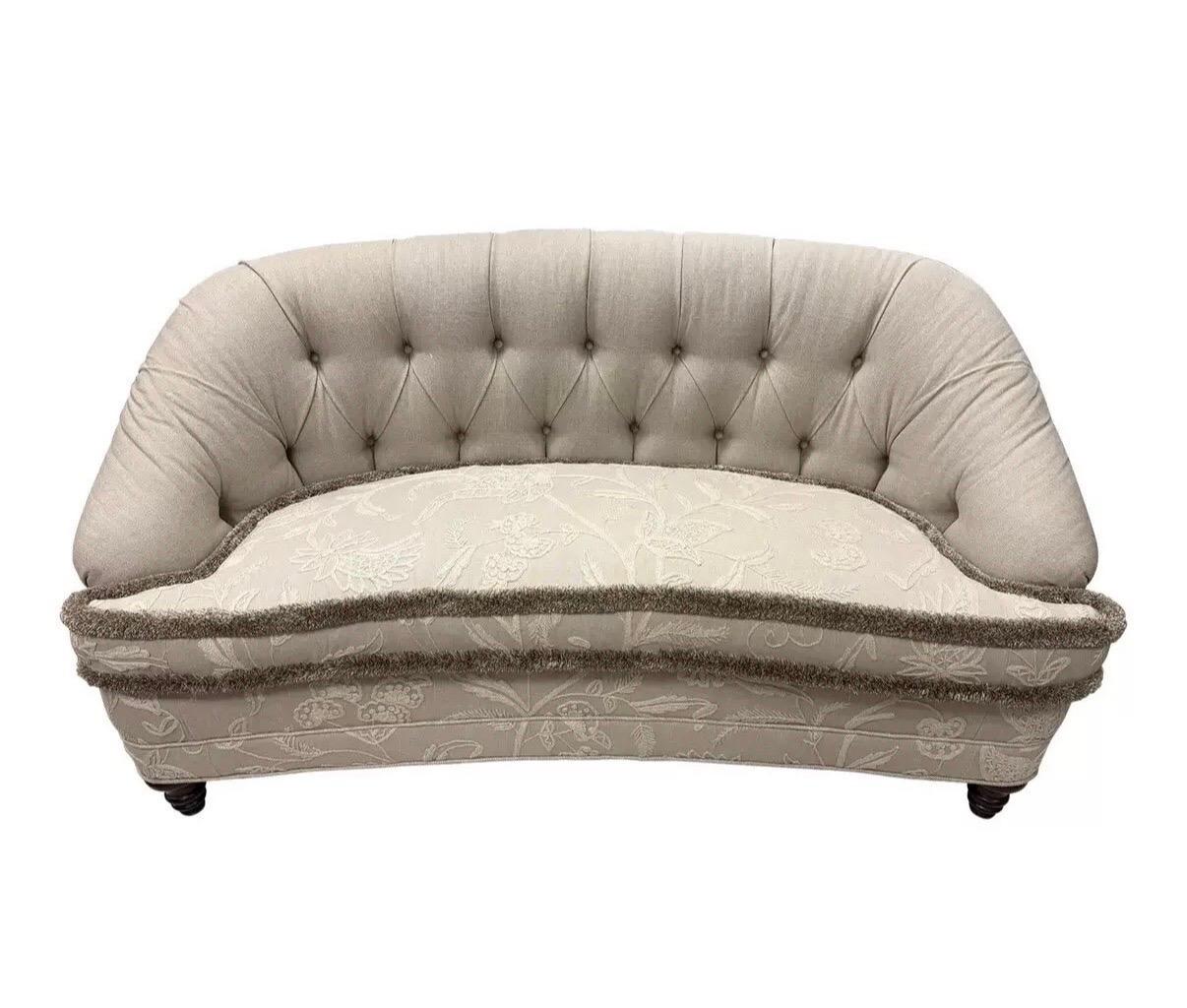 Elegant tufted loveseat sofa upholstered in a neutral greige fabric with coordinating trim.  Back and seat cushions are upholstered in crewelwork fabric with a floral motif.  Nothing short of spectacular.
