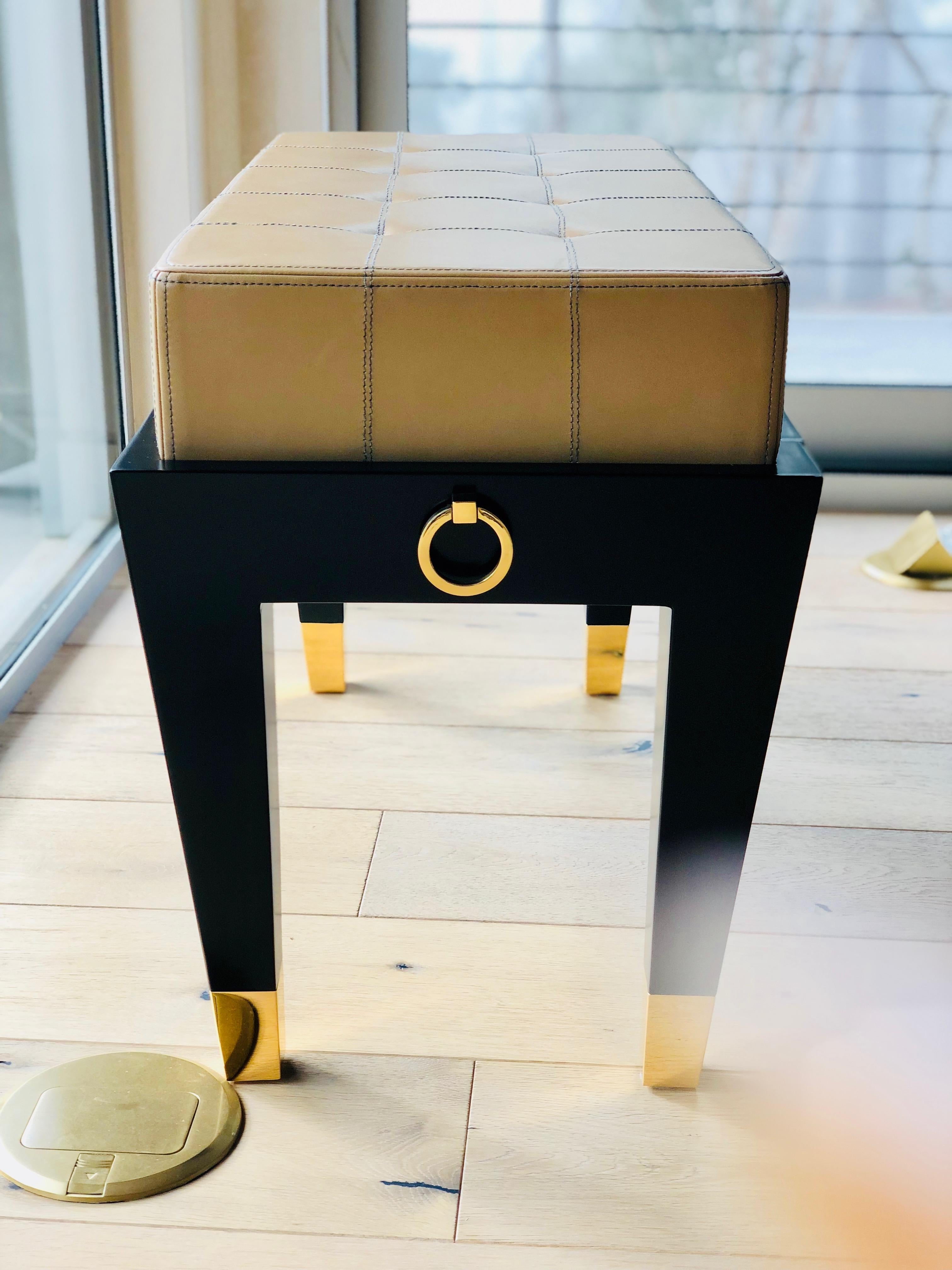 Create your own custom piano bench for a truly gorgeous finish to the piano room. 

The frame is black lacquer polished with a small drawer. The upholstered top is COM COL, tight upholstered with double seaming. Brass casters and gold ring detail.