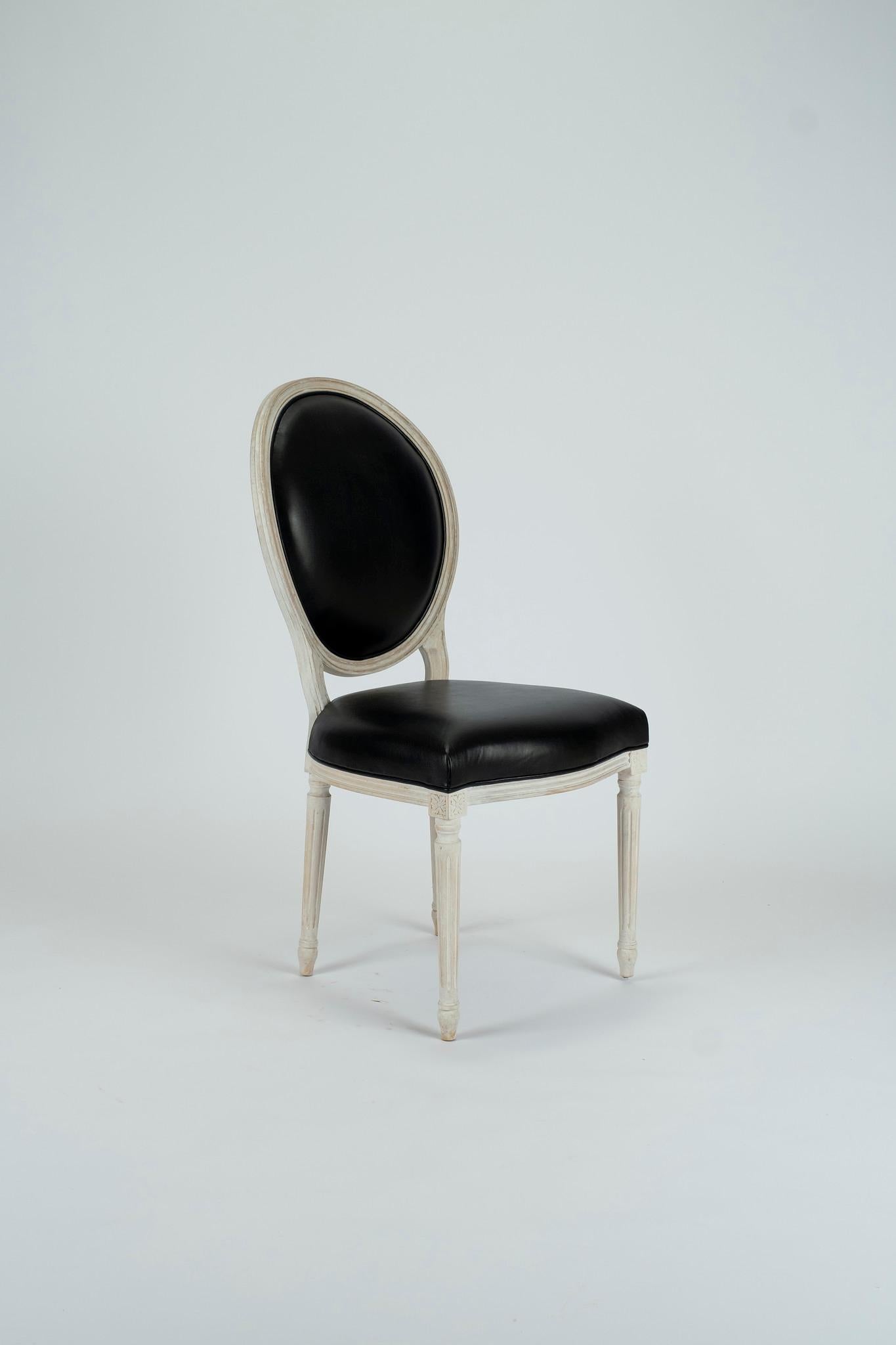 A custom white waxed Italian beechwood frame upholstered in black leather.

Also available C.O.M.