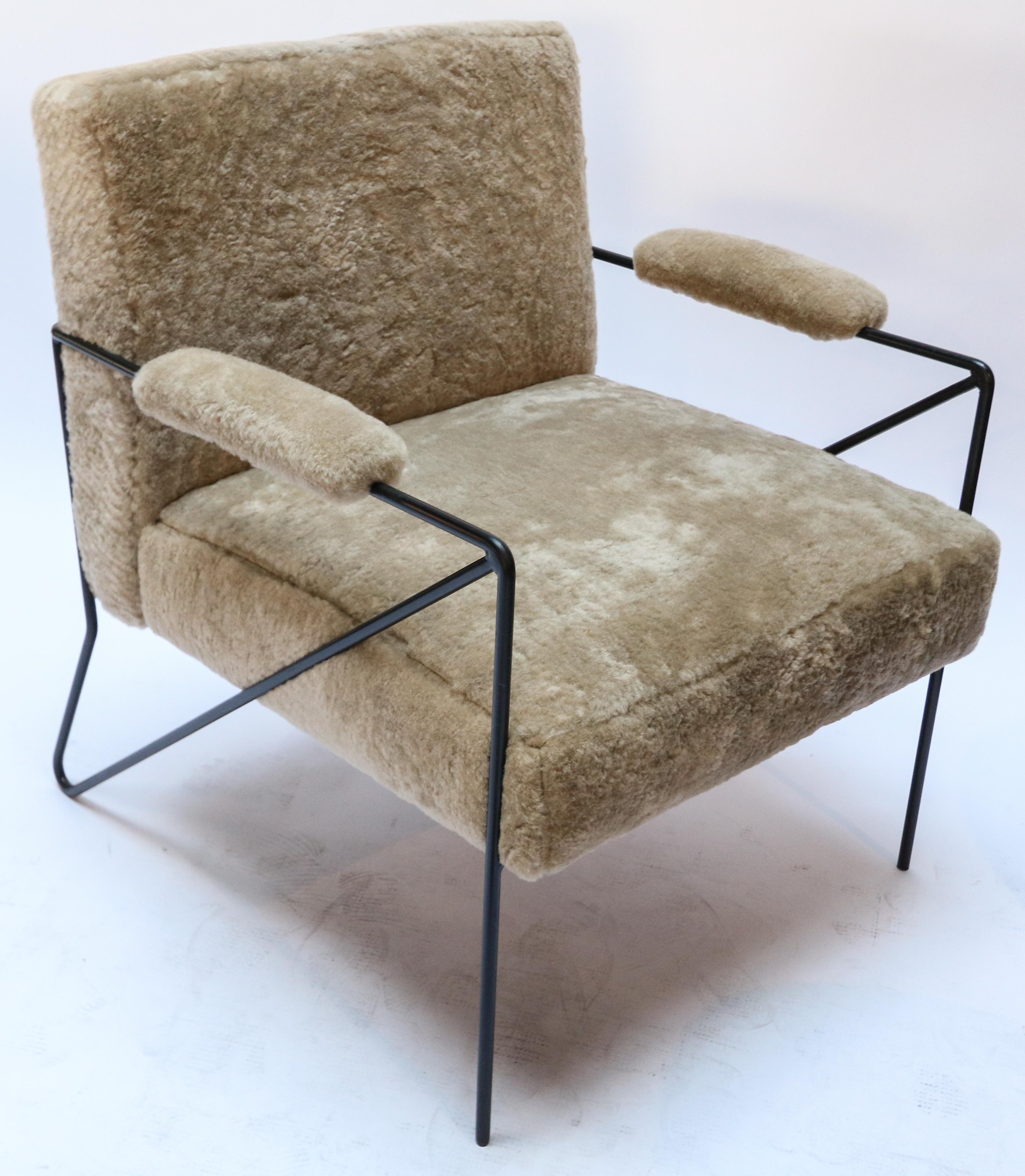 Custom black metal armchairs with tan sheepskin upholstery. Made in Los Angeles by Adesso Imports.

Measure: seat depth 21