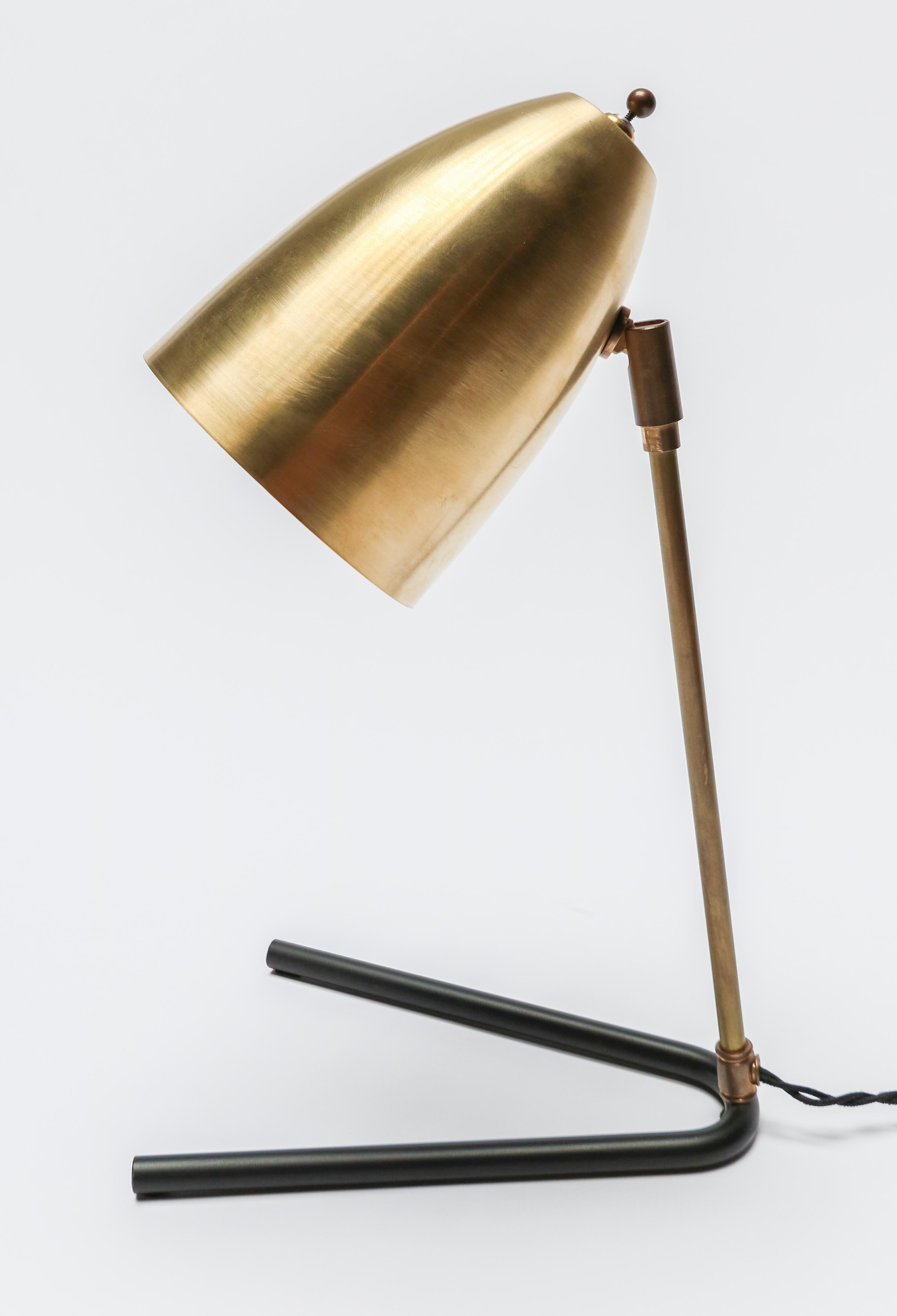 Custom midcentury style desk lamp with brass shade and black metal base by Adesso Imports.